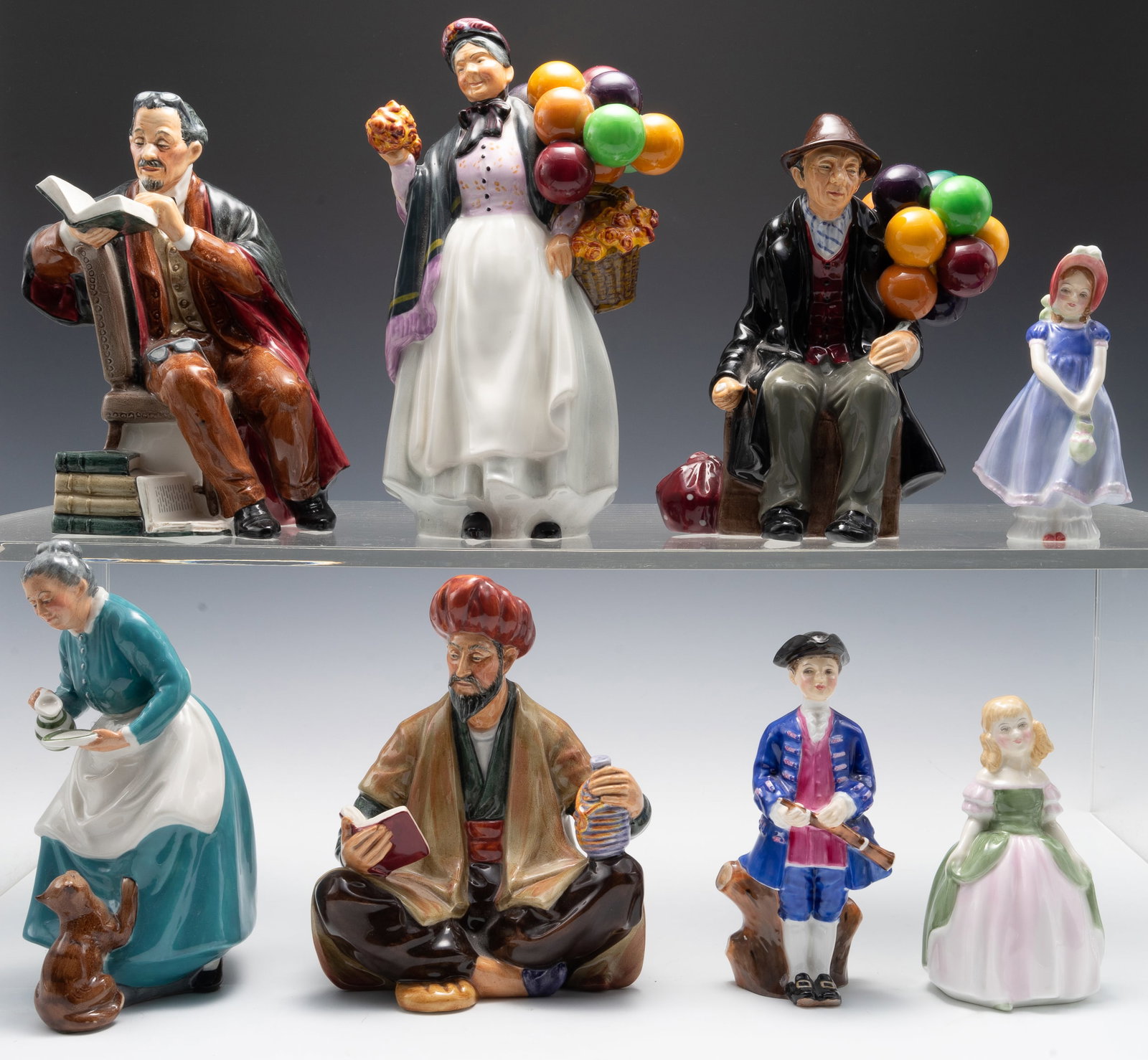 Lot of Royal Doulton Figurines.: The lot includes 8 figurines ranging from 4 3/4" - 9" in height. The figures included are Omar Khayyam, Biddy Pennyfarthing, The Professor, The Balloon Man, The Favorite, Ivy, Penny, and Boy from Will