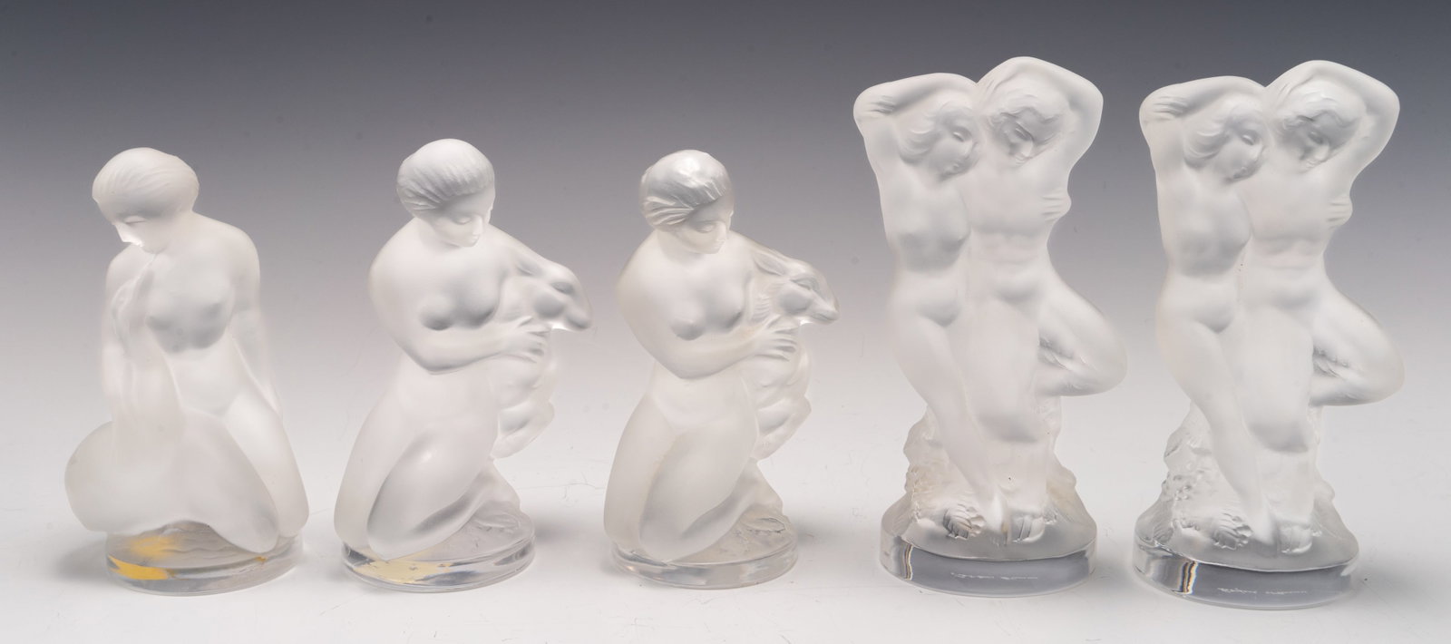 Lot of Lalique Frosted Crystal Nude Figurines.: The lot includes five small nude woman figurines. The smallest measures 4 1/2" tall, while the tallest measures 5 1/2". All of them are signed under the base. There are minimal scratches on a few piec