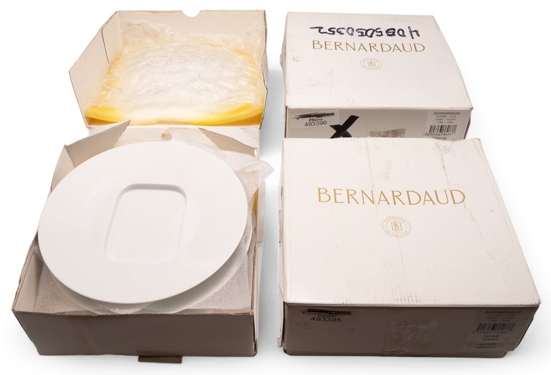 12 Bernardaud Porcelain Sardine Plates - NEW.: This lot consists of 3 sets of 4 white sardine plates, in their original boxes. They were made in Limoges, France by the manufacturer Bernardaud. They measure roughly 9 1/2" in diameter. The style is