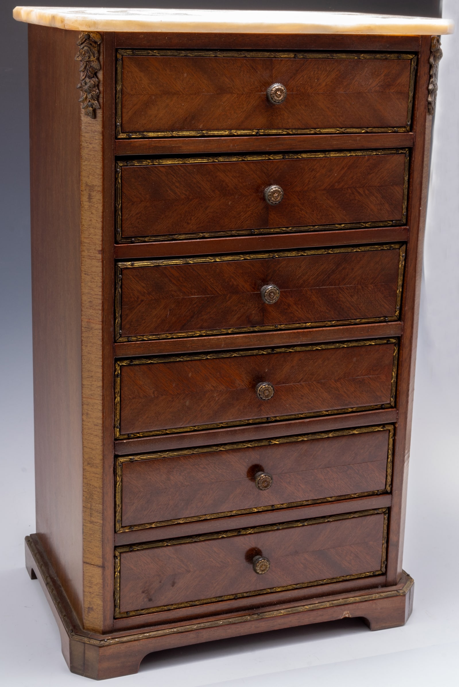 French Mahogany Wood Jewelry Chest w/ Marble Top.: This chest has six drawers, each one bearing a flower-shaped knob. Each drawer has Gilded bronze trim. The chest is also decorated with flower-shaped Bronze ormolu. Overall, the piece looks to be in V