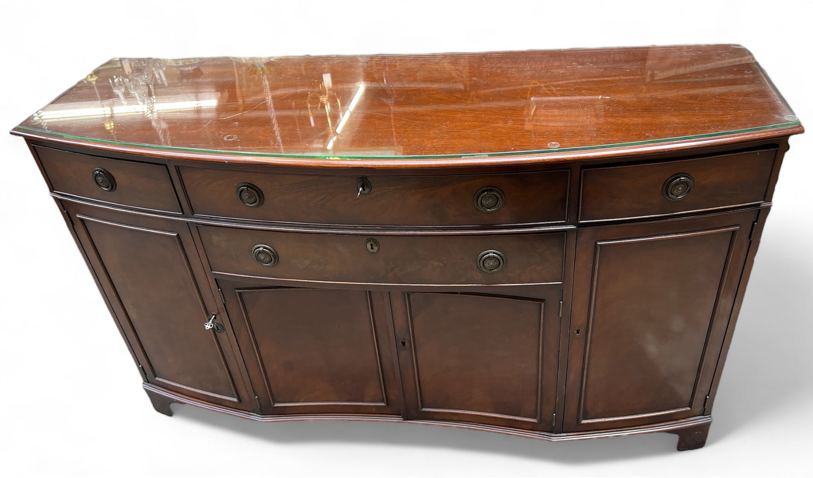 Mahogany Buffet.: This buffet, sideboard, or credenza has four drawers, four doors with inner shelving, and a storage area. It comes with two keys and has a protective glass top. The piece is in used condition and has 