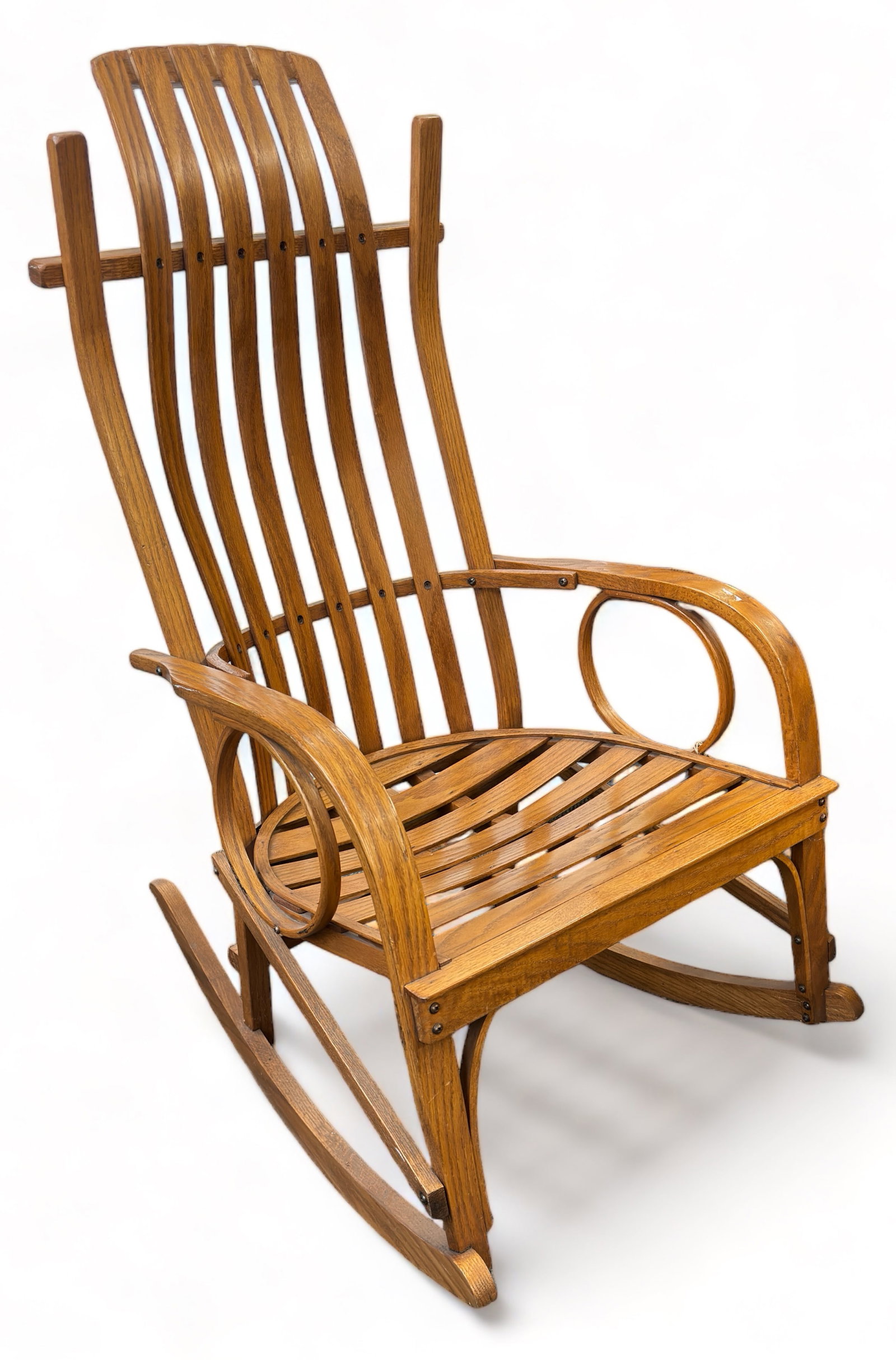 Slat Back Rocking Chair.: This light wood (oak?) rocking chair is very handsome. It is both lightweight and sturdy. It is in great overall condition, with a small bit of residue on one of the seat slats. The chair measures 23"