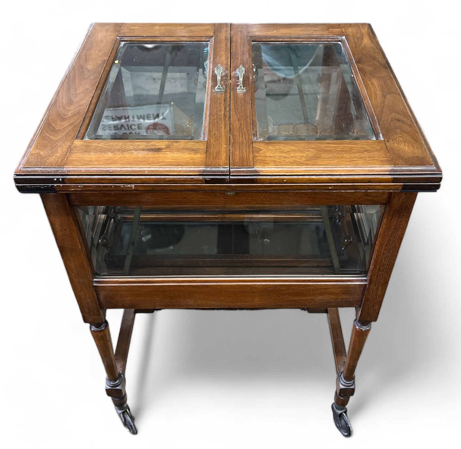 Walnut and Bevelled Glass Bar Cart.: This walnut and bevelled glass barcart has decanters, an ice bucket, a serving tray, ashtrays, etc. It has a lifting mechanism - when one opens the lid, the service tray rises to the top, and lowers w