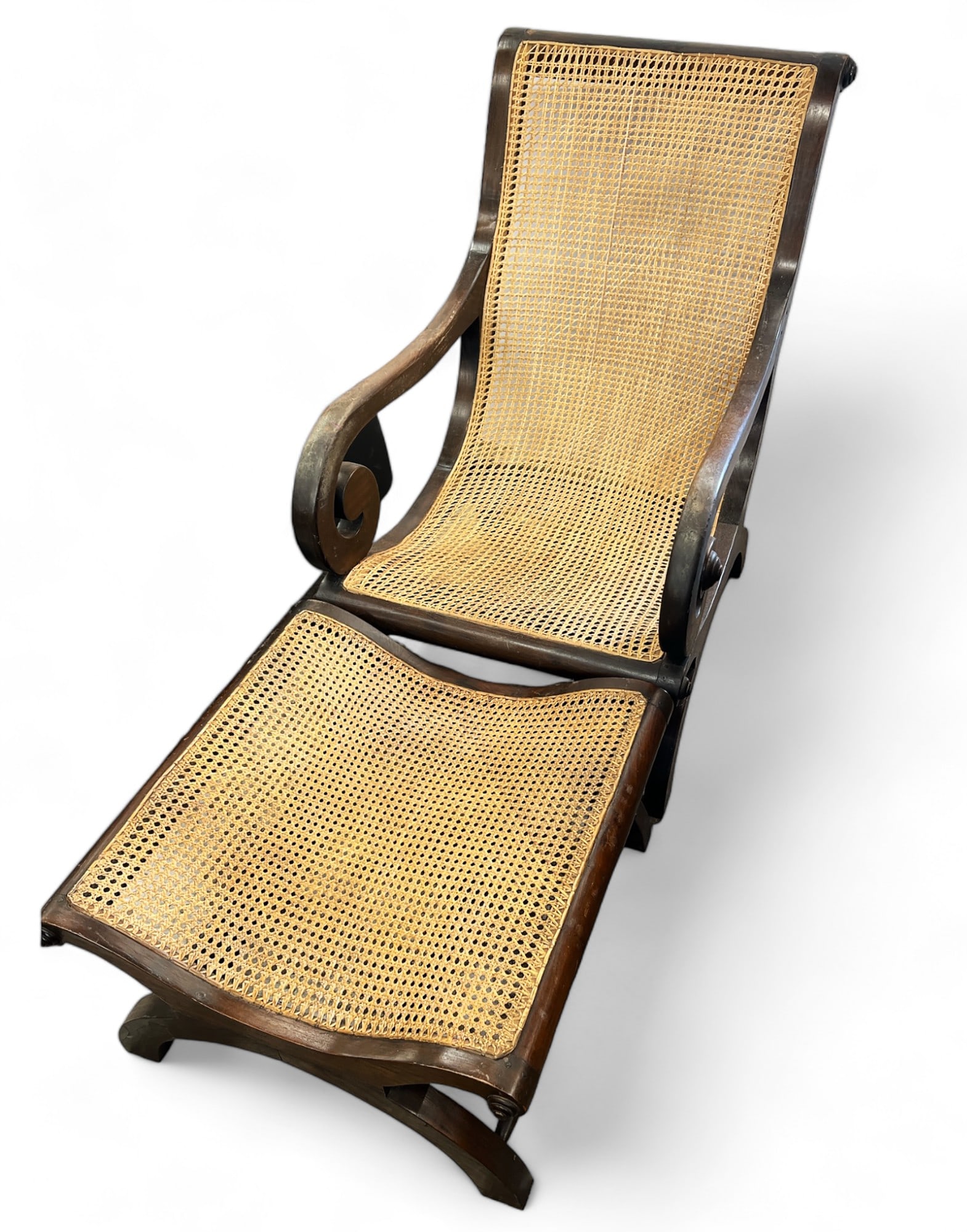 Plantation Style Armchair & Ottoman.: Both of these pieces have dark wood frames and scroll designs. The set is manufactured in Indonesia. While the cane seems to be in good condition with no visible damage, the dark wood frames have some