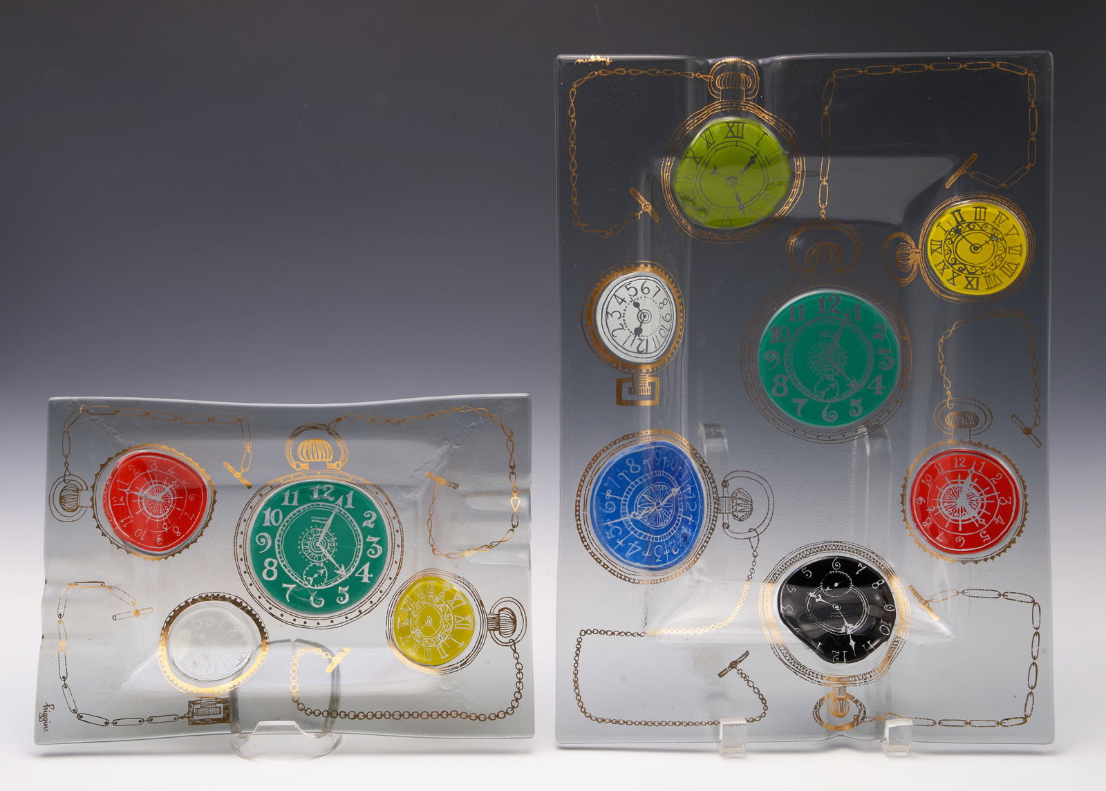 Lot of 2 Higgins Glass Ashtrays w/ Watch Motif.: It's likely that one ashtray is for cigarettes, and the other is for cigars. Both look to be in nice cosmetic condition. The larger one measures 13 7/8" x 10 1/8" x 1 1/8". In-house shipping is availa