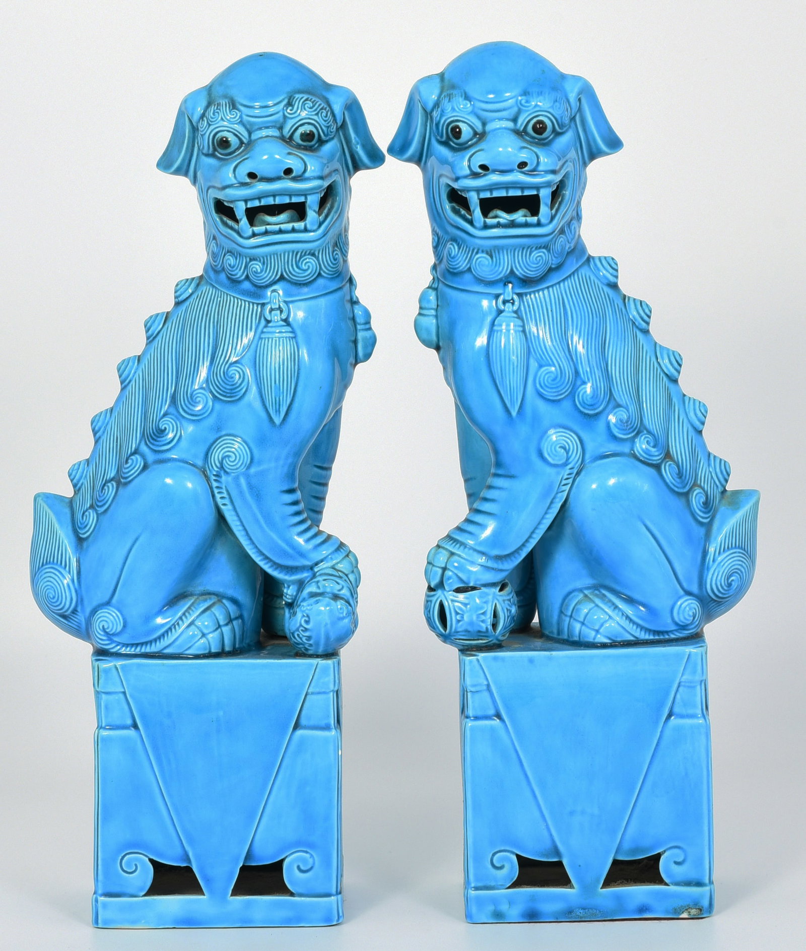 Pair of Majolica Chinese Foo Dogs.: One of them glaze missing on its base in a few places. Other than that, they are in good overall condition. They measure 12" tall, 4 3/4" wide, and 2 3/4" deep. In-house shipping is available. Please 