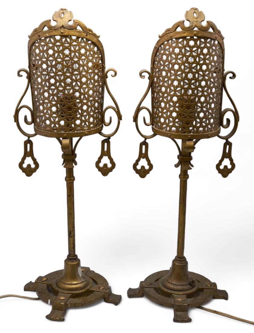 Pair of Vintage Wrought Iron Lamps.: The lamps are branded Leviton on the light sockets and on the switches. The lamps measure 22 1/2 tall x 8" wide. The top detail is bent back on both. The pieces have some paint chips, scratches, tarni