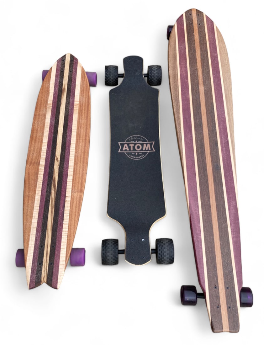 Lot of 3 Longboards / Skateboards.: They look similar to large skateboards, and appear to have seen minimal use. The black board is by Atom Longboards. The other two boards have striped designs, and are by an unknown maker. They more cl