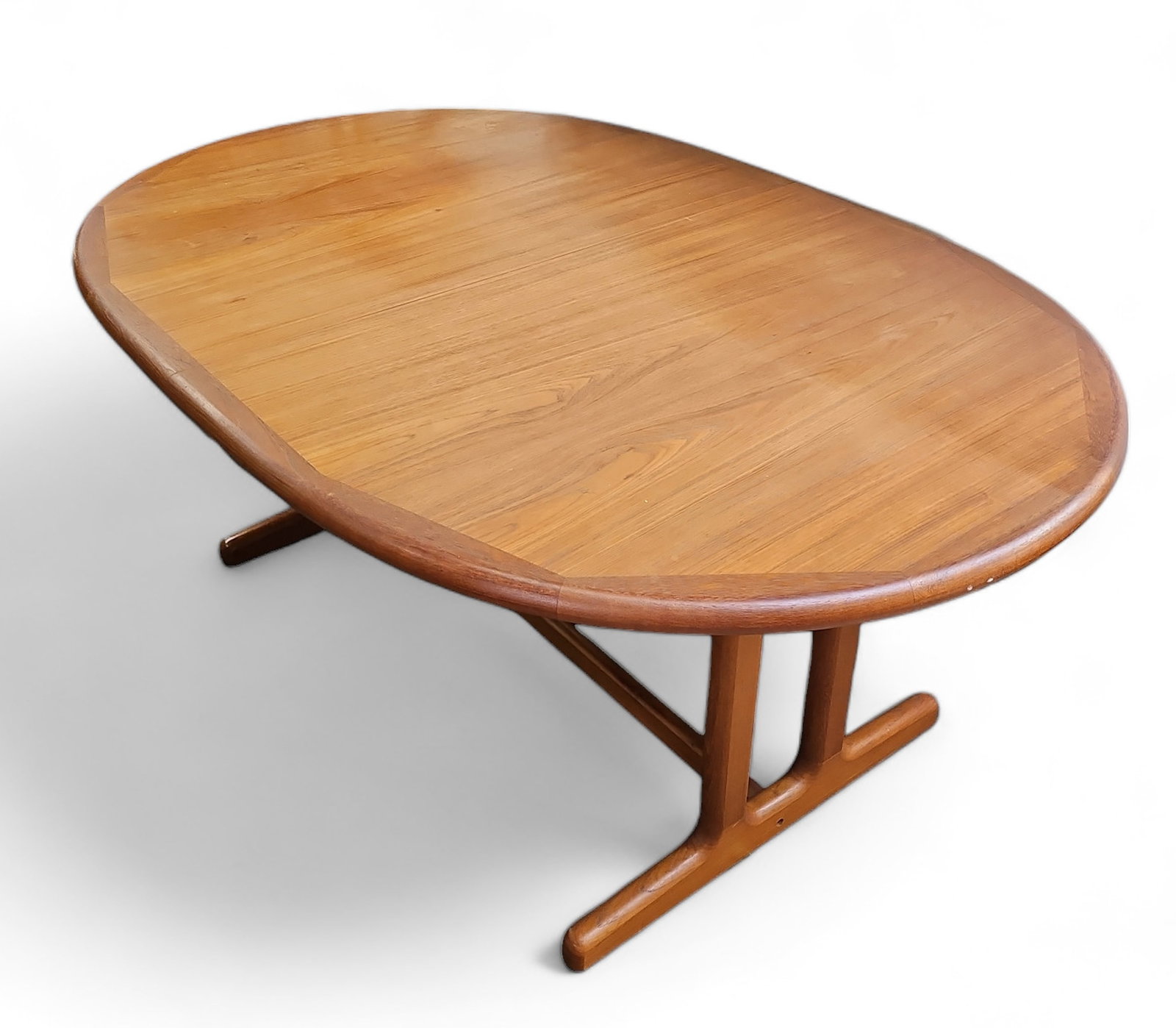 Danish Teak Dining Table.: The table is manufactured in Denmark. It has a large concealed leaf -- when the table is extended, the leaf pulls upward and attaches to the center. The table is in good condition, with just a few min