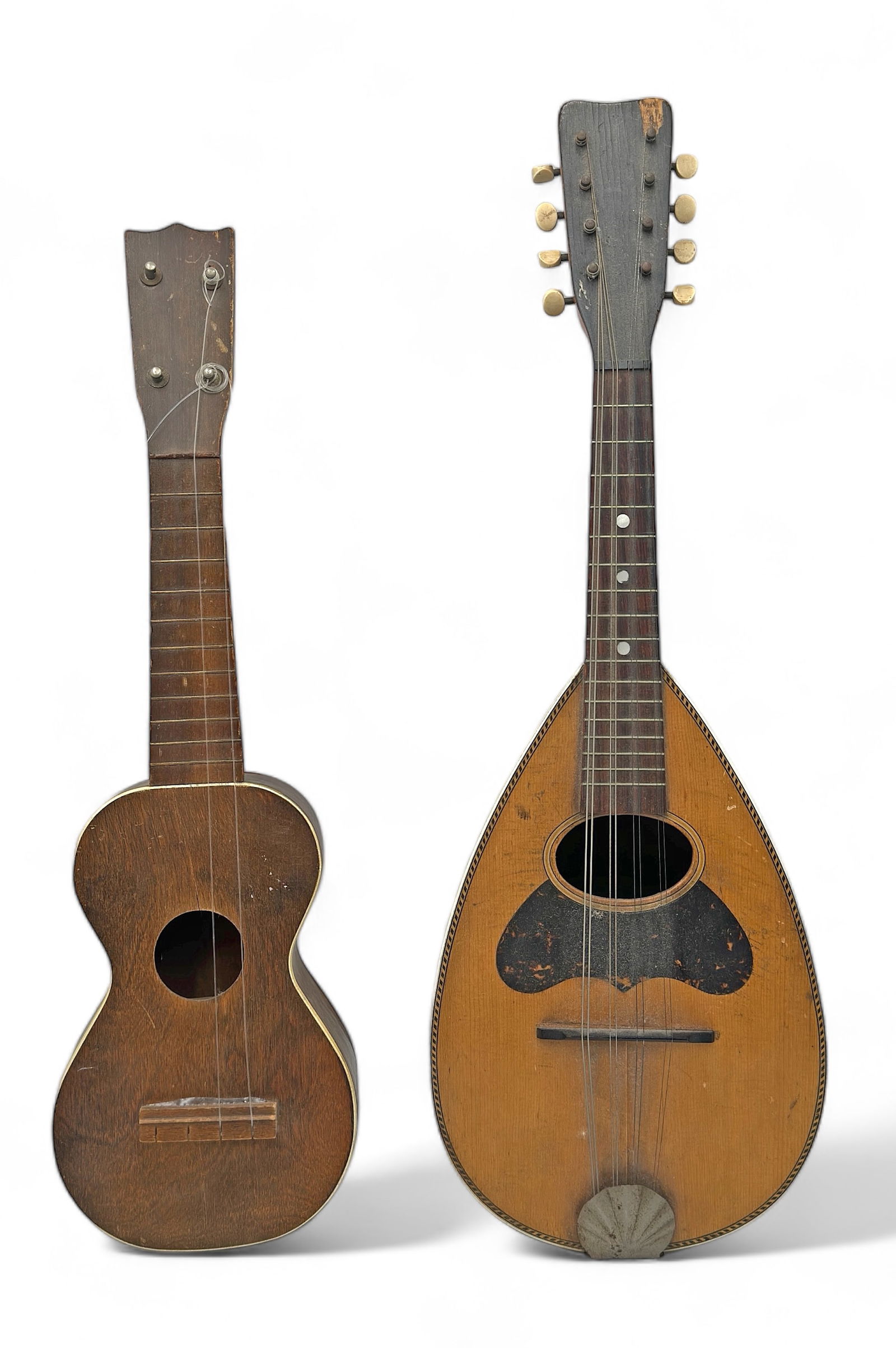Lot: 2 Pcs.: Mandolin & Ukulele.: The mandolin is marked "Criterion - Cleveland, Ohio." The ukulele is unmarked. The mandolin has a piece of veneer missing near the tuning keys, and lots of small scuffs and scratches. The ukulele is i