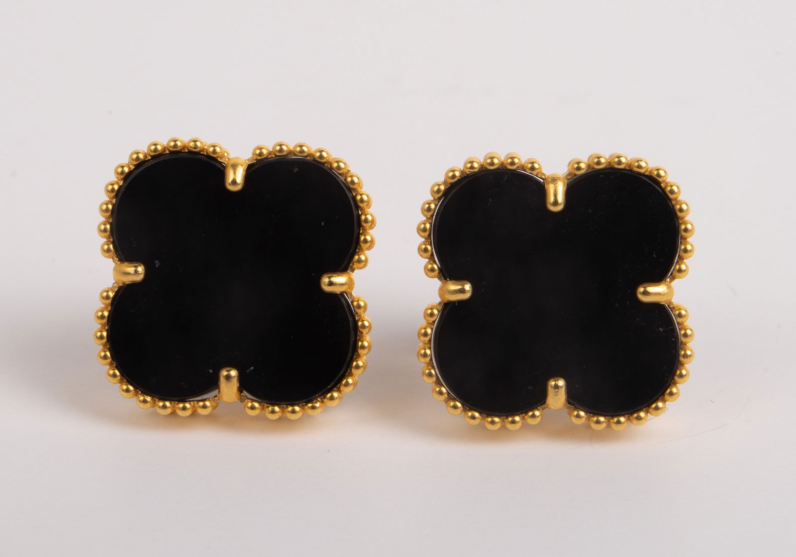 18K Alhambra Style Stud Earrings.: This pair of stud earrings is marked Au750 on the post. They feature an onyx four leaf clover. They measure 12mm x 12mm. They weigh 1.3 Pennyweight, or 1.9 Grams (including the stones). The pair is in