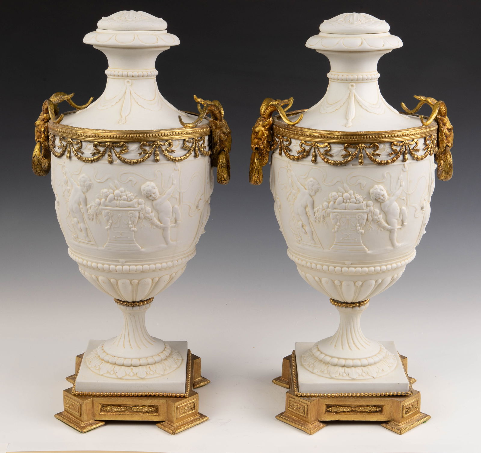 Pair of Bisque Porcelain Urns w/ Gilded Ram Heads. (1 of 11)