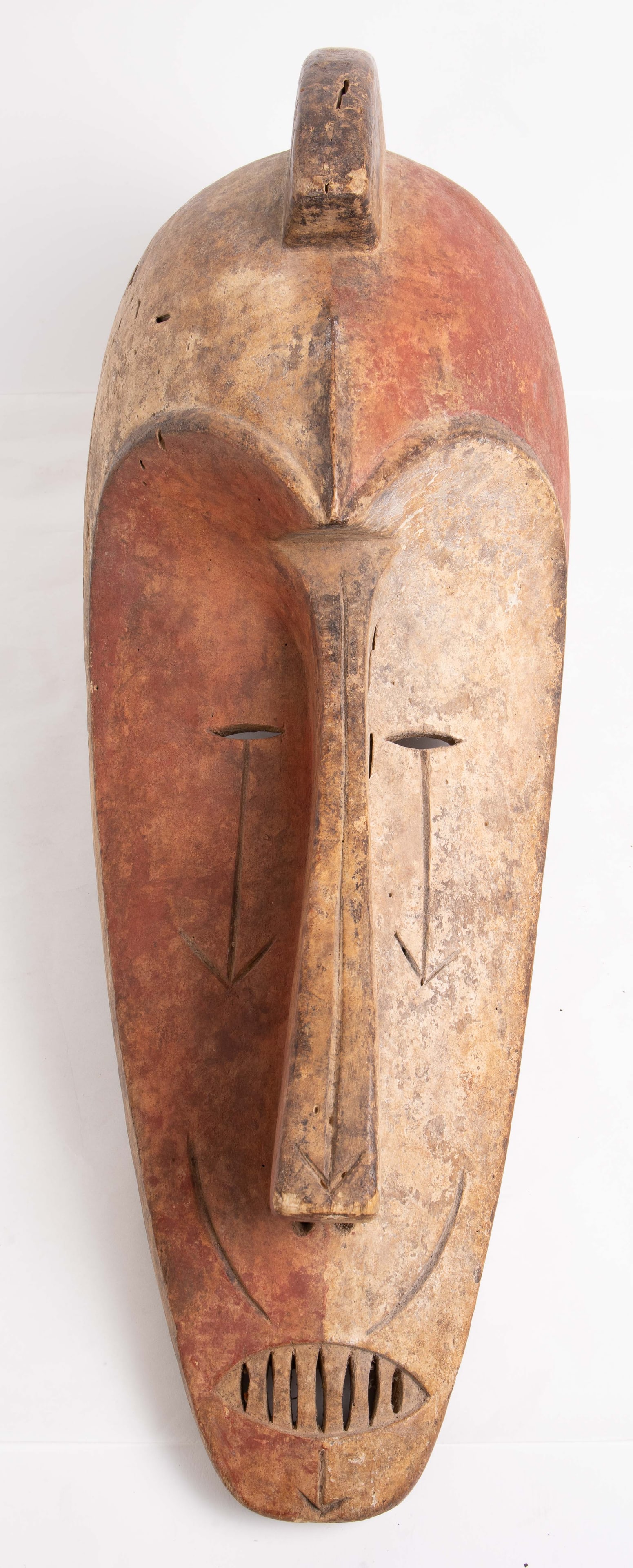 West African Carved Tribal Mask.: It measures 25 1/2" tall, 9" wide, and 12 1/4" deep. It has some small chips, cracks, and scratches. In-house shipping is available. Please see our website regarding in-house shipping procedures.