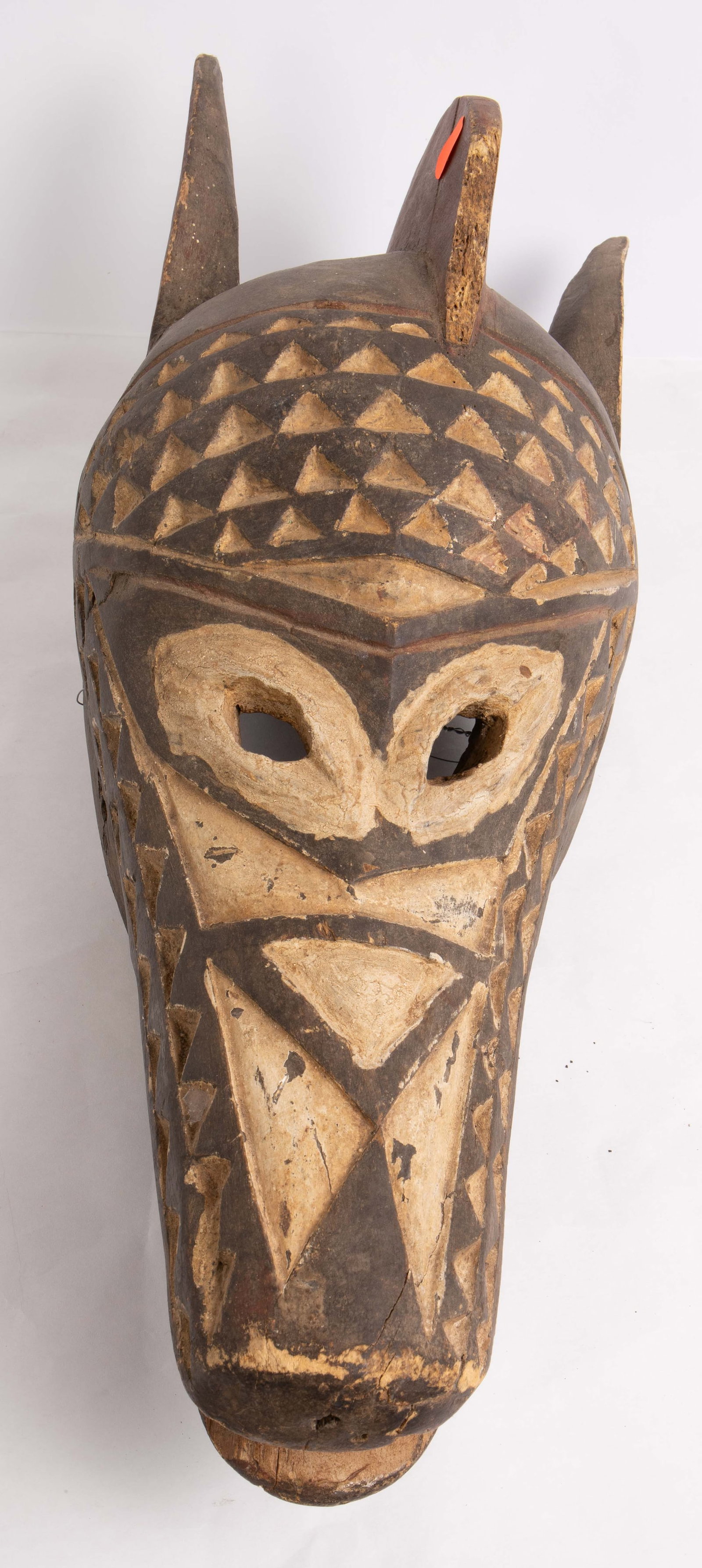 African Tribal Carved Donkey / Horse Mask.: The piece measures 23 1/2" tall, 8 1/2" wide, and 10 1/2" deep. It is missing the front tip of its foretop between the ears. It has some chips, scratches, and cracks. In-house shipping is available. P