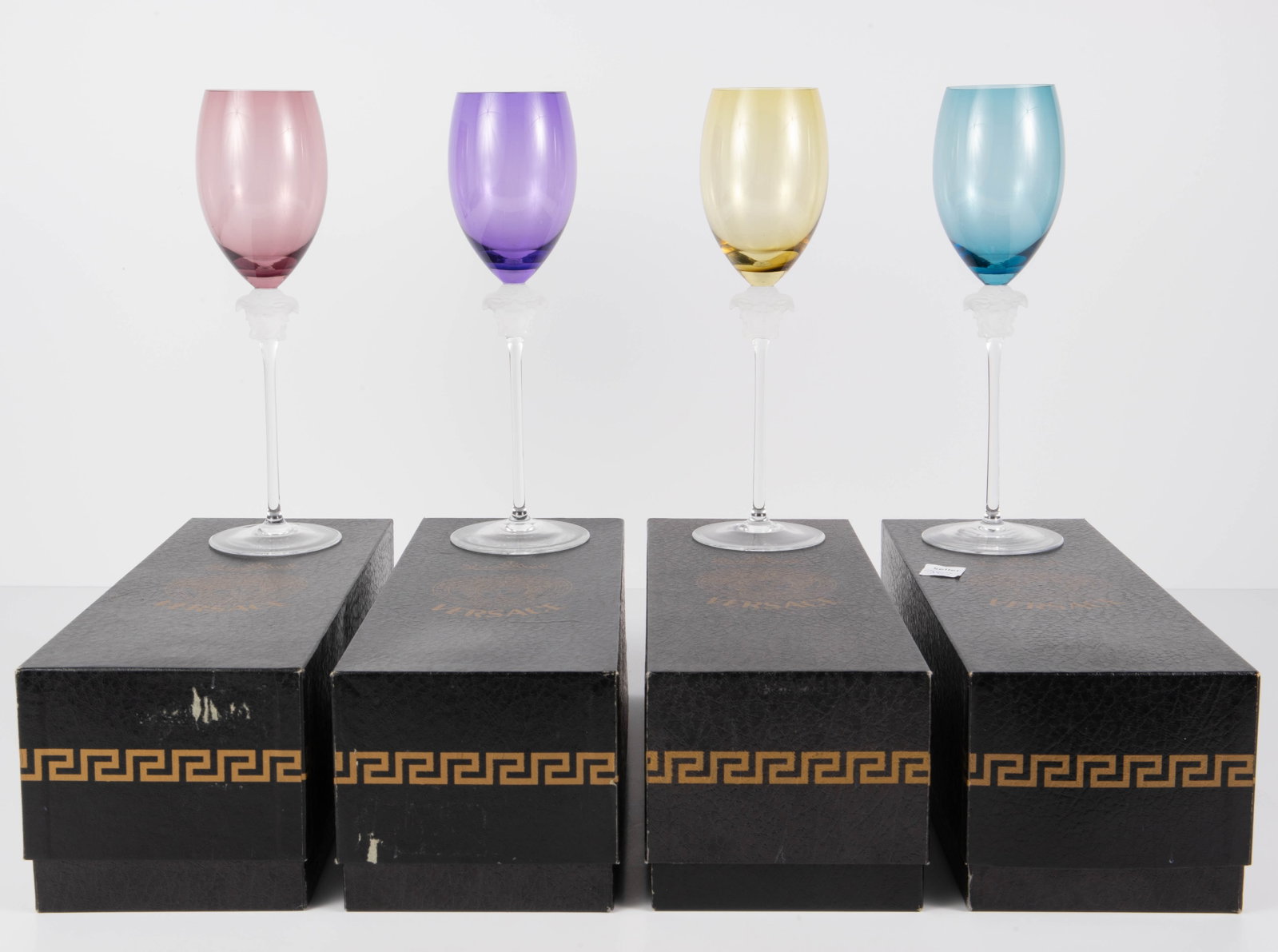 Rosenthal Versace Medusa Wine Glass Set of 4.: It is a set of 4 tall wine glasses, all with the original boxes. The bowls are different colors- blue, green, purple, and yellow. They all look to be in great condition. They measure 10 1/4" tall. In-