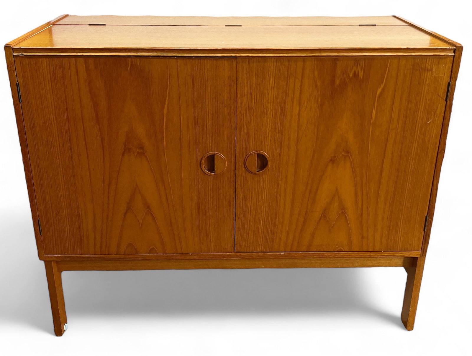 Danish Modern 2-Door Teakwood Cabinet w/ Lift Top: This cabinet has a tiny chunk missing out of its front left edge, otherwise it is in good overall condition. It is a slightly lighter color than the previous Danish Control pieces. It has a 1 1/2" dia