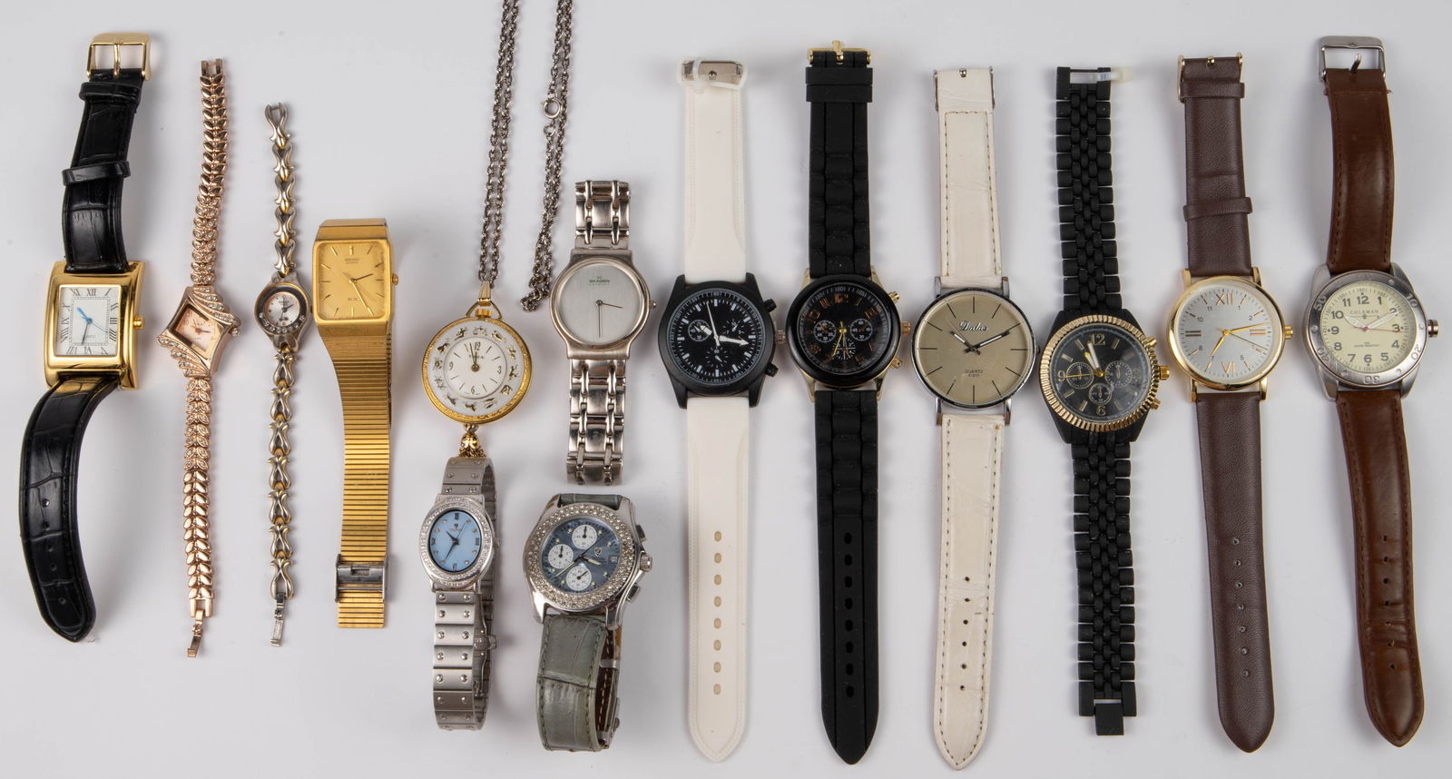 Lot of 14 Watches - Croton, Coleman, Trice, Etc.: The lot consists of 13 wristwatches, and 1 pendant watch on a chain. The brands included are Trice, Croton, Coleman, Skagen, Dalas, King Girl, QMax, and Seiko. The rest of the watches are unbranded. T