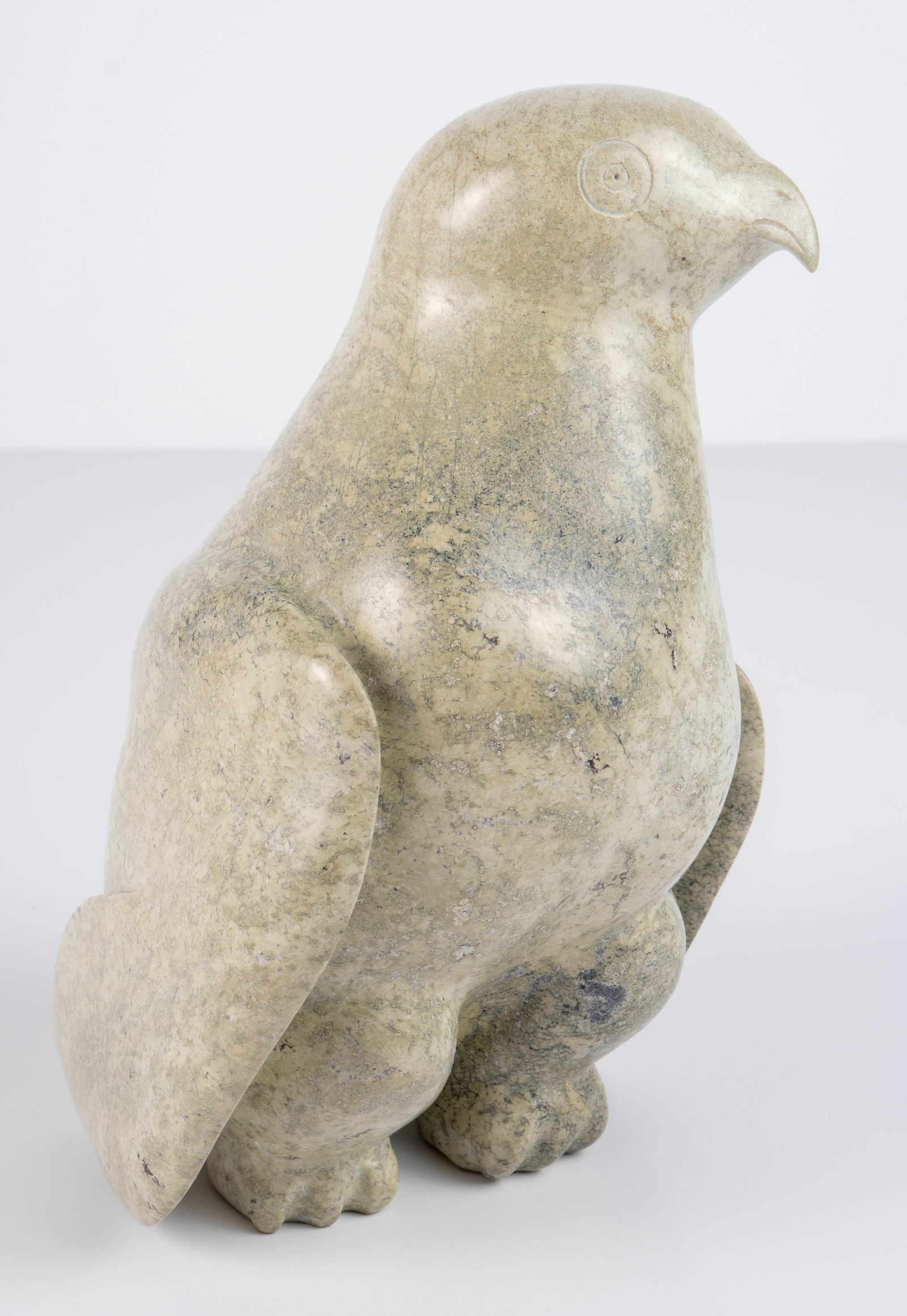 Canadian Inuit Stone Pigeon Sculpture.: The piece measures 8 1/2" tall, 5 3/8" wide, and 6 1/2" deep. It still holds the Canada Esquimo Art Esquimau sticker on the underside. It has a 3/4" chip on the tail, and the left wing tip appears to