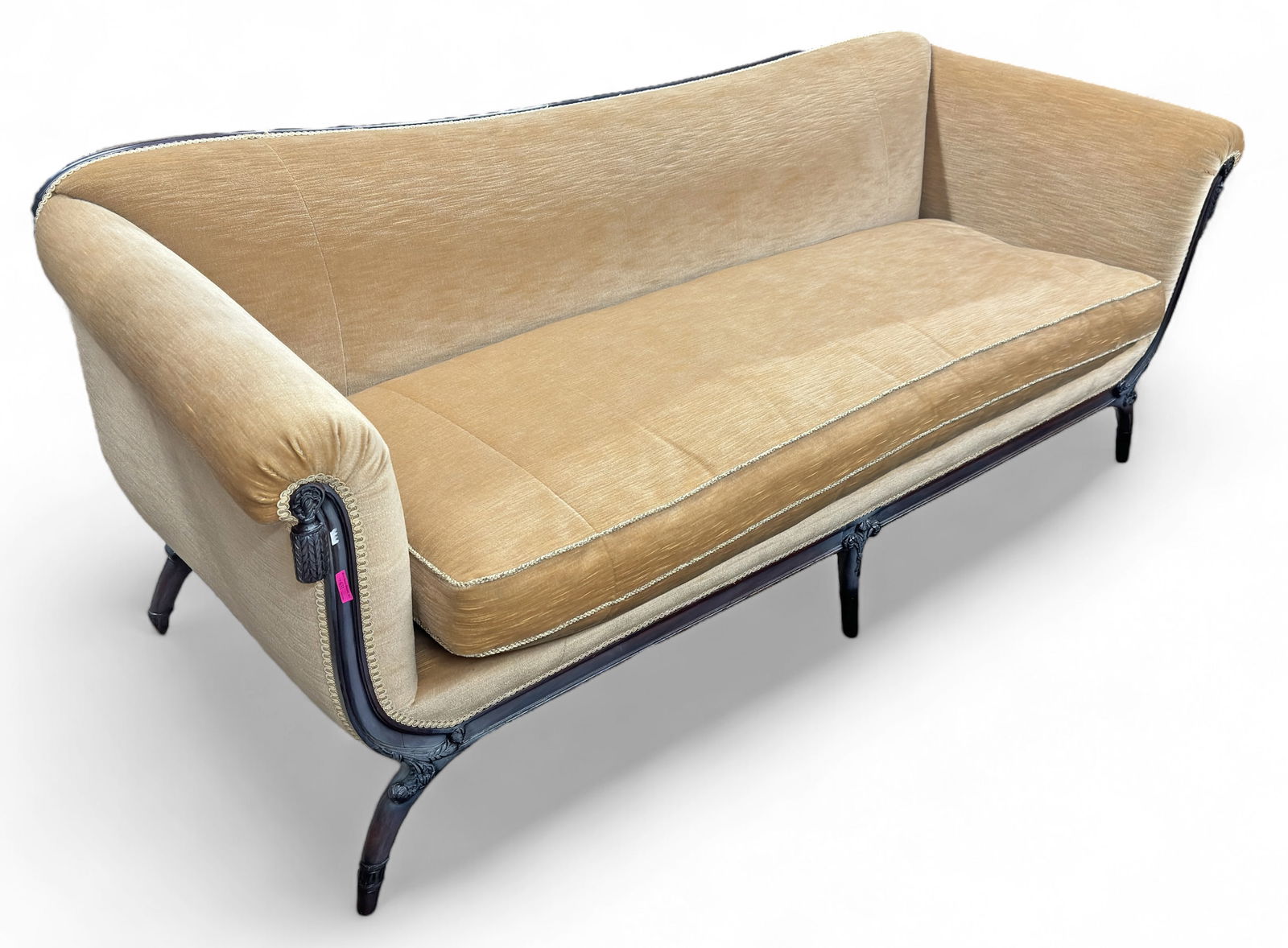 Vintage Carved Tan Upholstered Sofa.: This sofa features carved drapery style tassels, carved floral curved legs and tan upholstery. The seat cushion is removable. There are some minor scratches on the wood, but it is overall in good cond