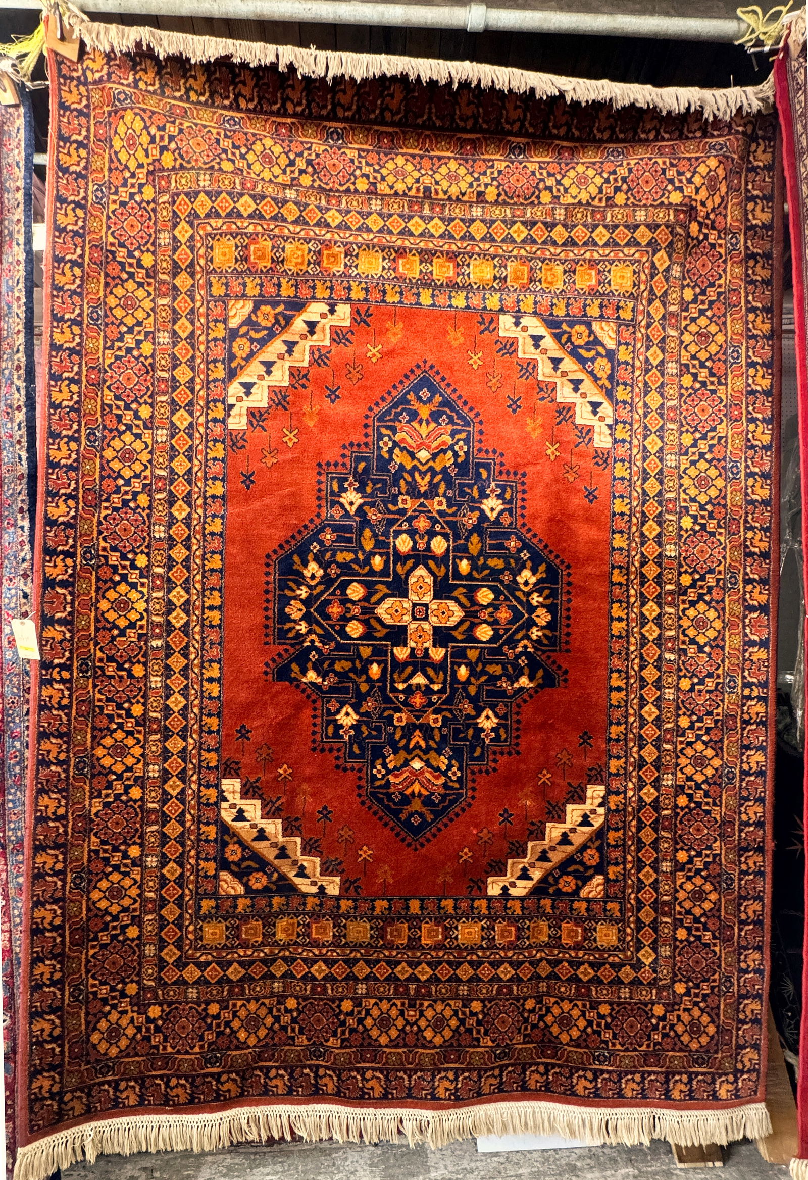 7' 8" x 10' 8" Rust Colored Rug w/ Cloth Backing. (1 of 3)