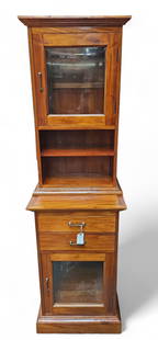 Di Lorenzo Cabinet.: The cabinet has a removable top half. Both the top and base have bevelled glass-front doors that hide large storage areas. The top half has two open shelves, while the bottom half has two drawers. The
