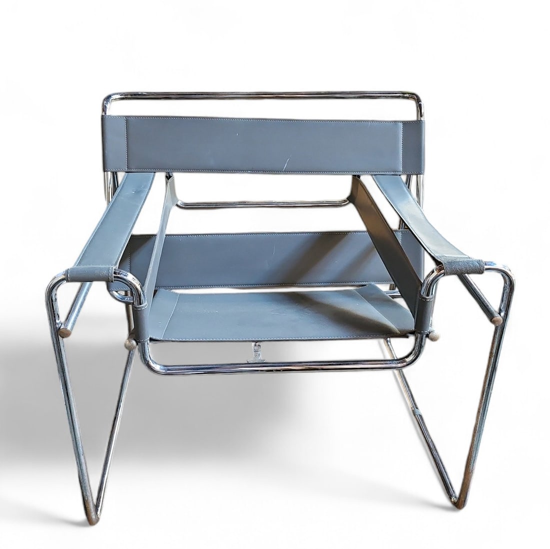 Chrome & Grey Leather Wassily Chair.: The leather shows wear in some places (one hand rest is quite worn), and the chrome has some pitting. The chair measures 29" tall, 30 1/2" wide, and 26" deep. Third-party freight shipping or personal