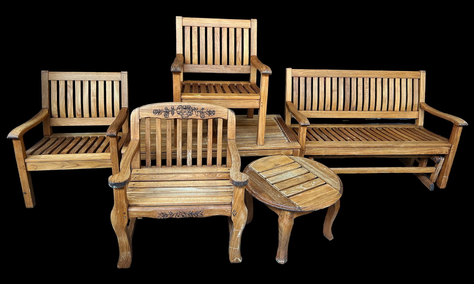 Teak Patio Furniture Set by Gloster & Others.: This set is comprised of a pair of armchairs, a large coffee/center table, and a glider bench by Gloster Furniture Company. Also included is a teak armchair and a round table manufactured by Kingsley