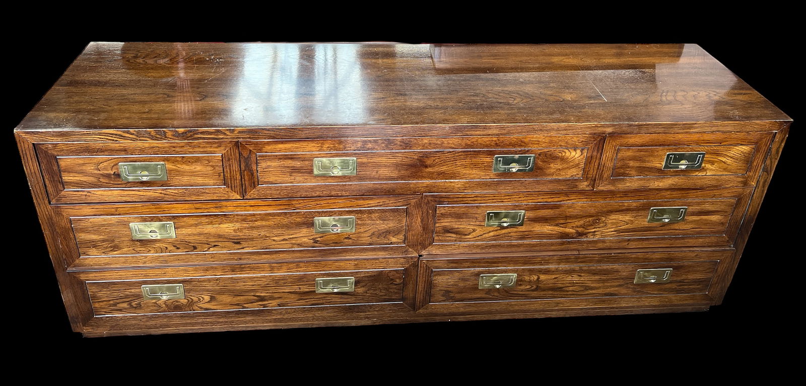 Henredon Campaign Style Dresser.: This dresser has a lacquered finish, and has seven drawers with brass hardware. It is signed inside the top right drawer. A few of the drawers have removable dividers. There are some scratches and scu