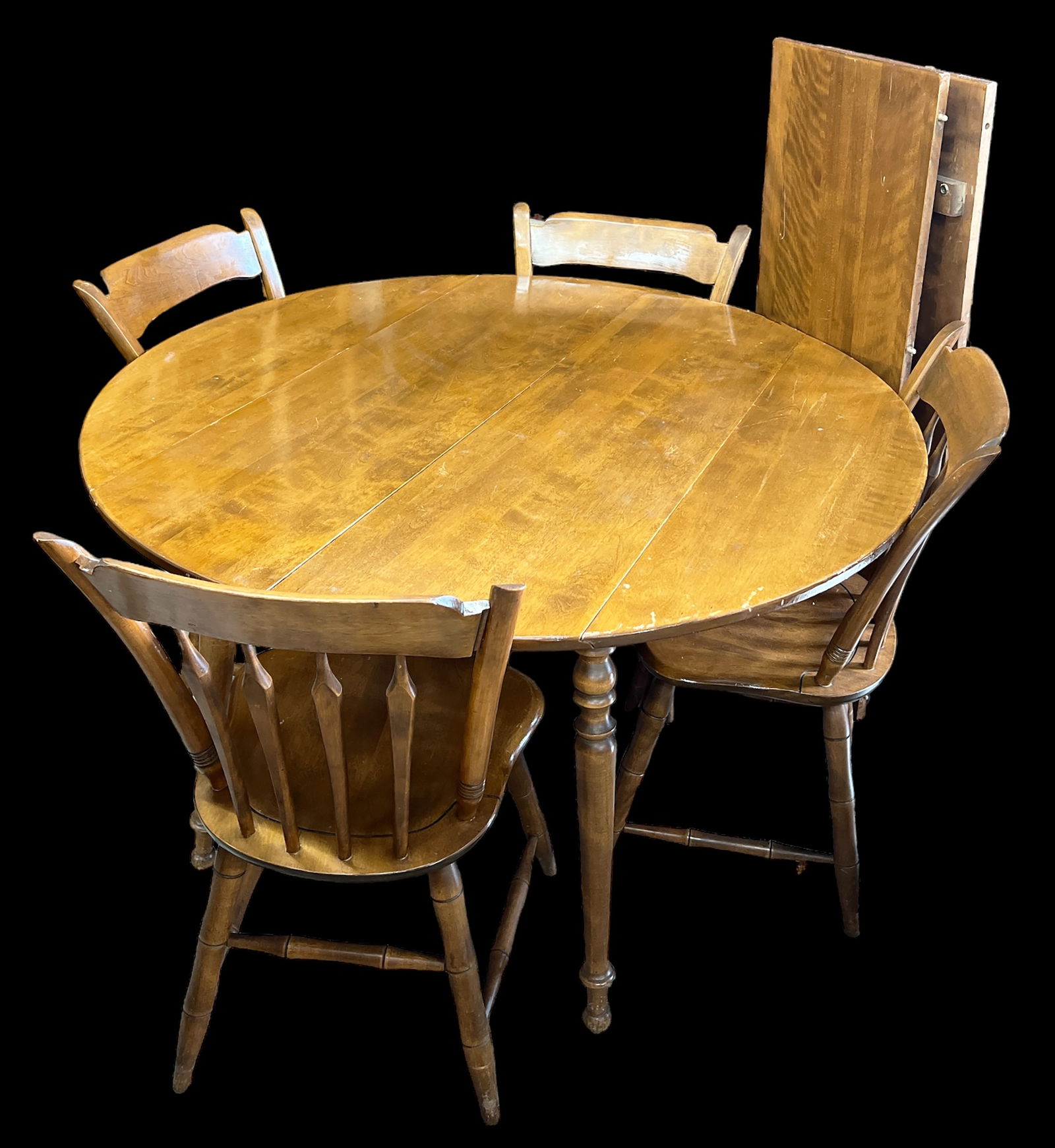 Ethan Allen Dining Table with Four Chairs.: The set is made from maple and birch. The table is round, but the sides can drop down, and leaves can be added (two are included). All of the pieces are in good condition, with minor wear and scratche