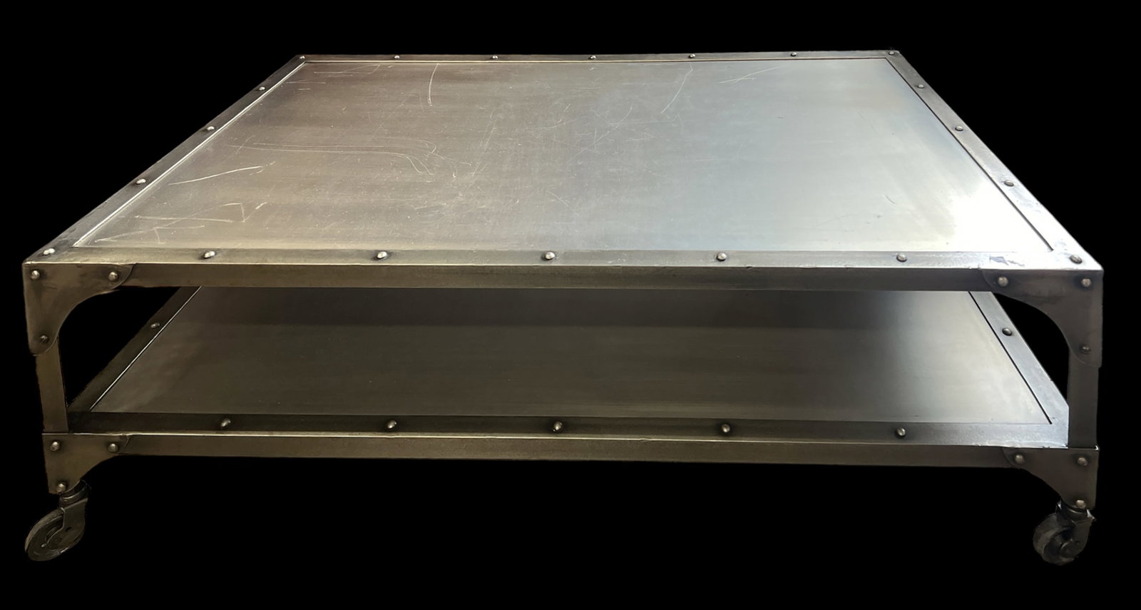 Element Metal Coffee Table.: This contemporary coffee table sits on casters, and has a nailhead design. It has a fair amount of scratches on the surface. It measures 49" wide, 27 1/2" deep, and 17" tall. Third-party freight shipp