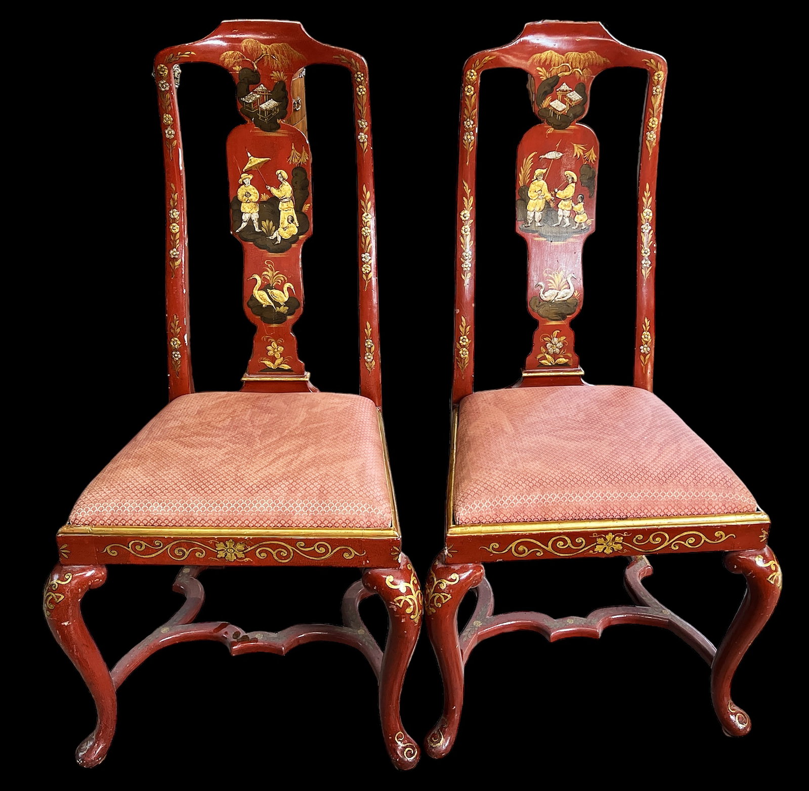 Pair of Chinoiserie Style Chairs.: These red and gold chairs feature paintings of houses, people, flowers, and birds. They have pink upholstered seats. There are some scratches and scuff marks, but overall the chairs are in good condit