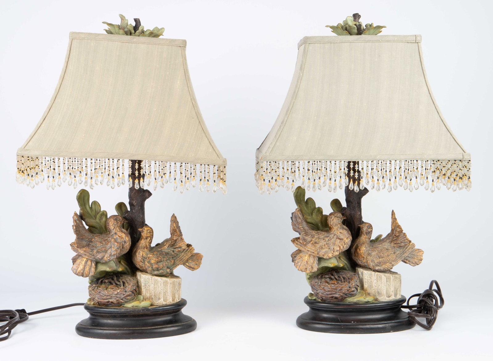 Pair of Vintage Nesting Doves Composite Lamps.: This pair of lamps feature a pair of birds and a nest with eggs. They measure 25" tall, 15" wide, and 10 1/4" deep (with the shades on). There are some scratches and grime on the pieces. Otherwise, th