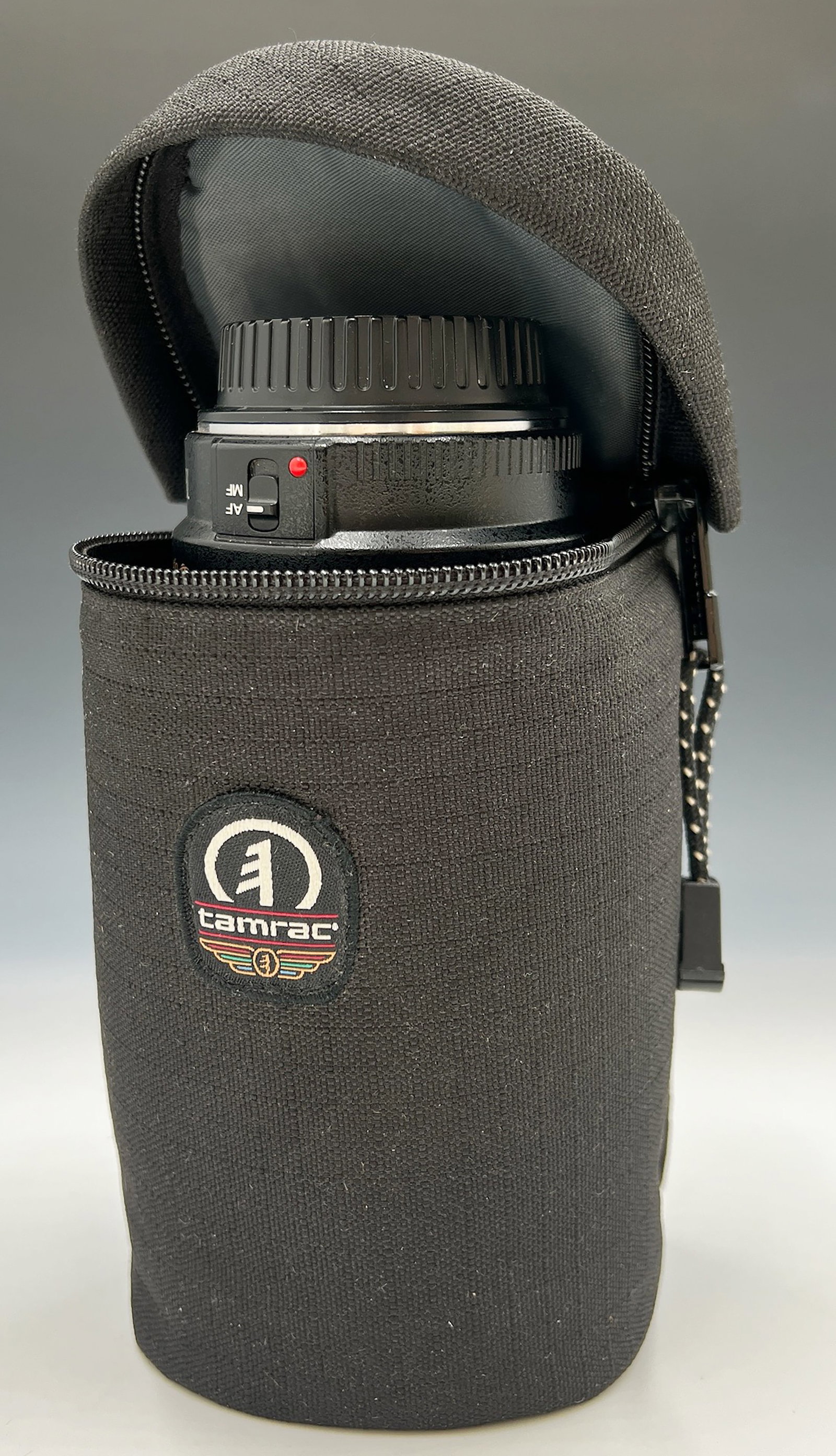 Canon EOS 70-300mm f/4-5.6 IS USM Zoom Lens.: The lens comes with caps, a hood, a soft case, and a Calumet UV Filter. It has clean glass (just a bit of internal dust), smooth manual focus, and smooth zoom. The autofocus functionality has not been