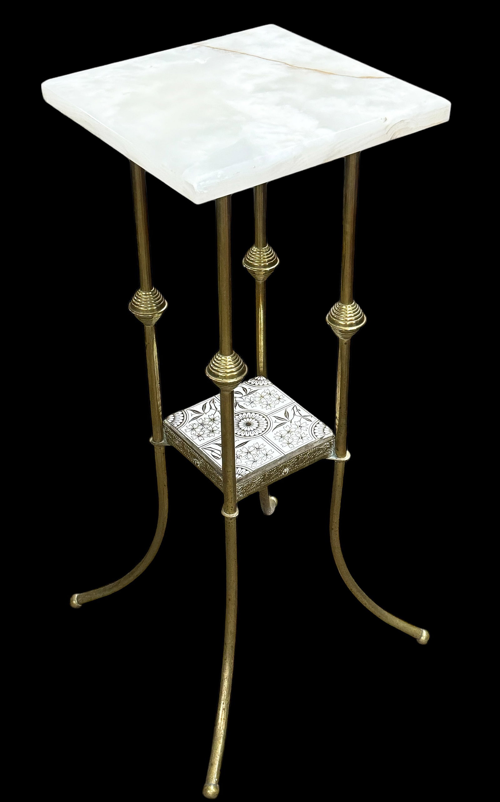 Victorian Brass and Onyx Pedestal.: The onyx has been professionally repaired on this two tier pedestal stand. It has a bit of damage along one edge, nonetheless. The bottom tier has a victorian tile insert, with intricate details. Ther