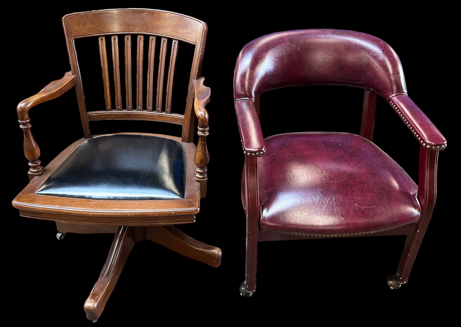 Lot of Two Office or Library Chairs.: The banker's chair has leather upholstered arms, slat backs, and metal casters (one caster is missing). Also included is a Burgundy leather (possibly faux leather) side or desk chair. It has nailhead 