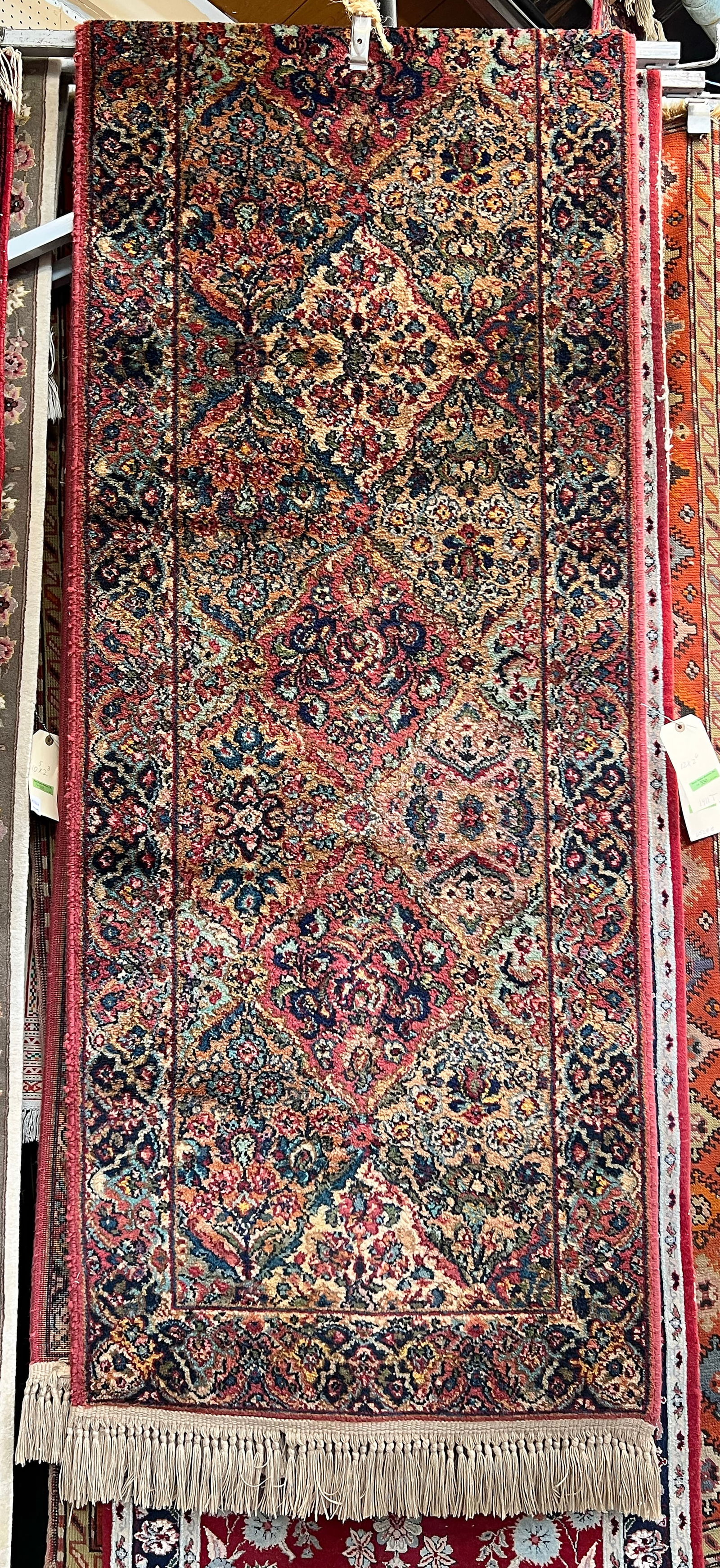 2' 6" x 12' Panel Kirman Karastan Runner Rug.: This multicolor rug is in good overall condition. It still has the original Karastan tag on it. In-house Shipping is Available for this Rug. Please see our website for in house shipping procedures.