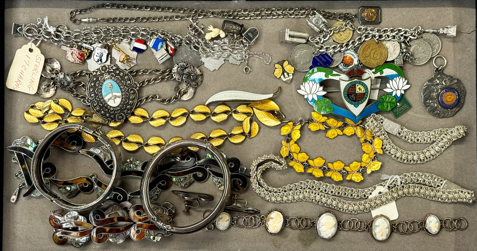 Lot Silver Jewelry - Enamel, Cameo, Charm Bracelet: This mixed lot includes 19 pieces. The lot includes matching sets, bangles, brooches, and charm bracelets. First, there is a Mexican silver necklace and bracelet set, with small flower details along t