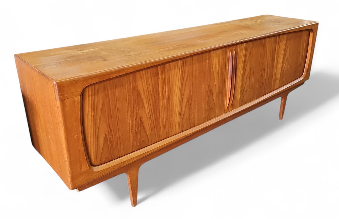Mid-Century Modern Teak Credenza.: This Danish credenza is in the style of Bernhard Peterson & Son. It features tambour doors that wrap around the piece, and three center drawers. There are some water stains, scratches, and a few dark