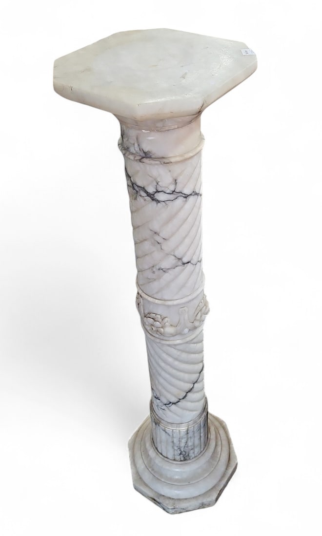 Antique Marble Pedestal.: This white and gray marble pedestal has fruit carvings in the center column. The top lifts off for easy transportation. There are some scratches and a few chips. Overall, it is in good condition. It m