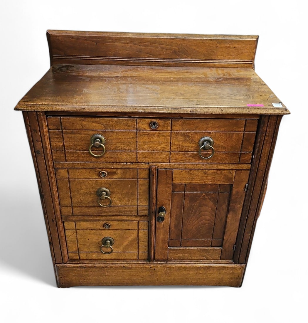 Antique Victorian Washstand.: This dark wood washstand has three drawers with brass pulls, and one door with a wood pull. The drawers have keyholes, but no key is included. There is a split on the top of the piece, and some warpin