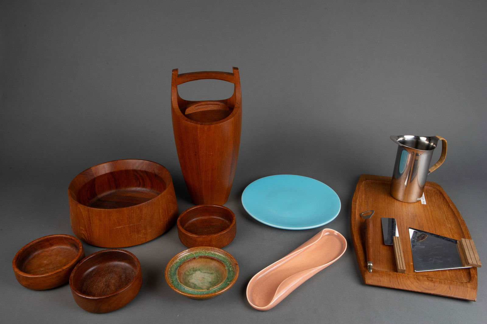 Mid Century Serveware - Dansk, Teak, Sgd Pottery.: This lot consists of 13 pieces. First, there are 3 pieces of pottery: an ashtray signed Dessauer (small chip), an 11" blue plate signed Catalina Island, and an elongated light coral color 13" dish sig