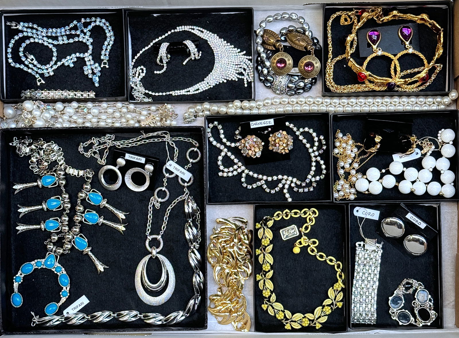 26 Pieces Vintage Costume Jewelry - Trifari, Etc.: The lot consists of 26 pieces of vintage costume jewelry - many of them are signed. There are 14 necklaces, 7 pair of earrings, and 5 bracelets. The brands included are Monet, Trifari, Coro, and Carne