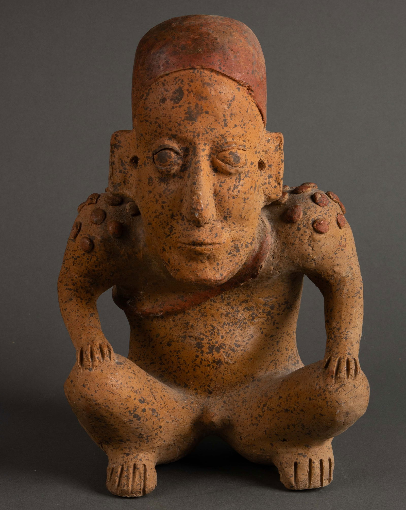 Pre Columbian Squatting Warrior Redware Sculpture.: This sculpture measures 12 1/2" tall, 8 1/4" wide, and 8 1/2" deep. It has some shallow cracks, mainly by the feet, and a 1" chip along the sack strap. The item also has some scratches. In-house shipp