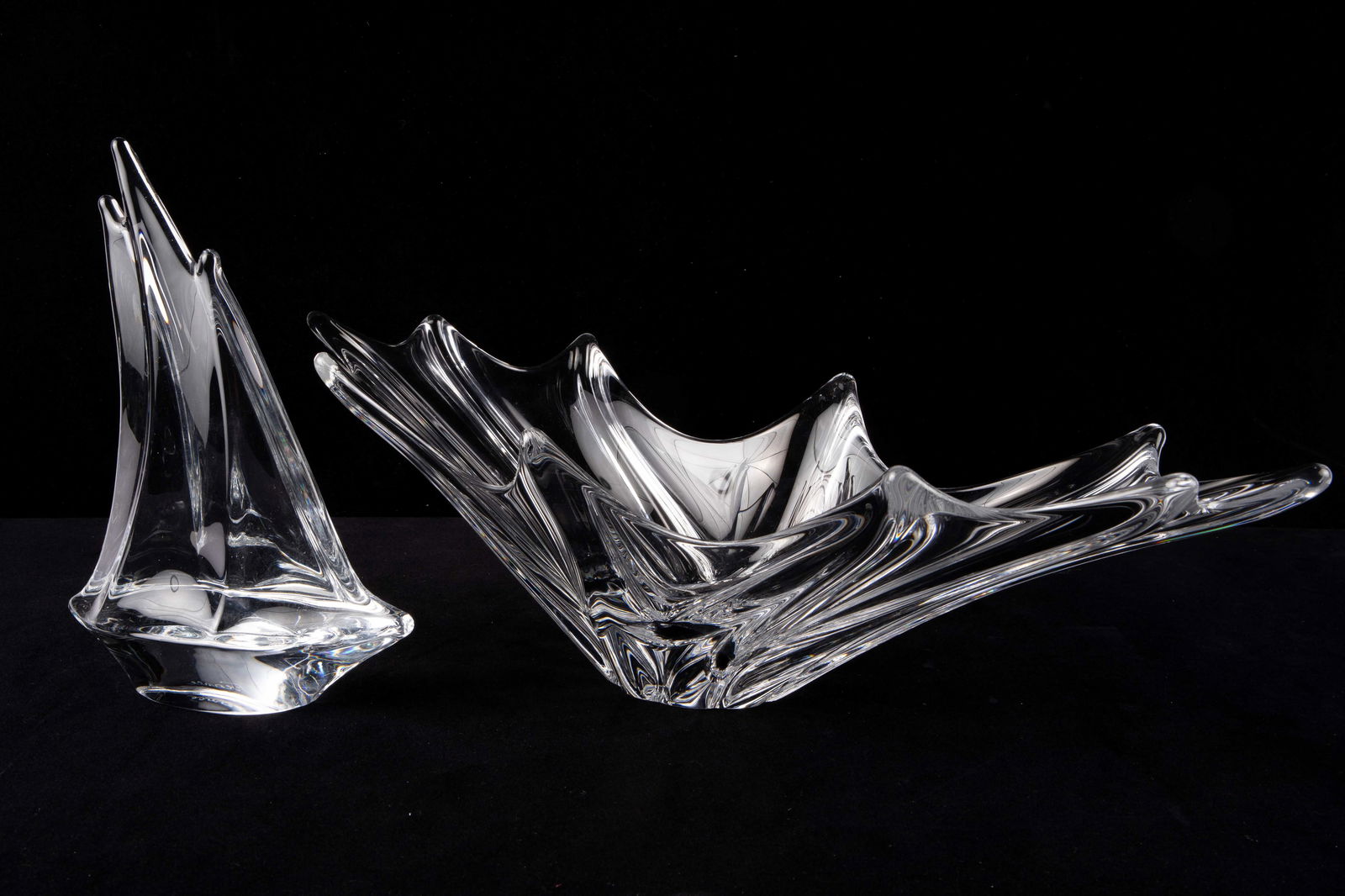 Lot: Daum France Crystal Boat & Centerpiece Bowl.: Both pieces are signed, and the sailboat still has the original sticker. The lot looks to be in very nice condition. The bowl is the larger item, measuring 21" x 7" x 5 1/2". In-house shipping is avai