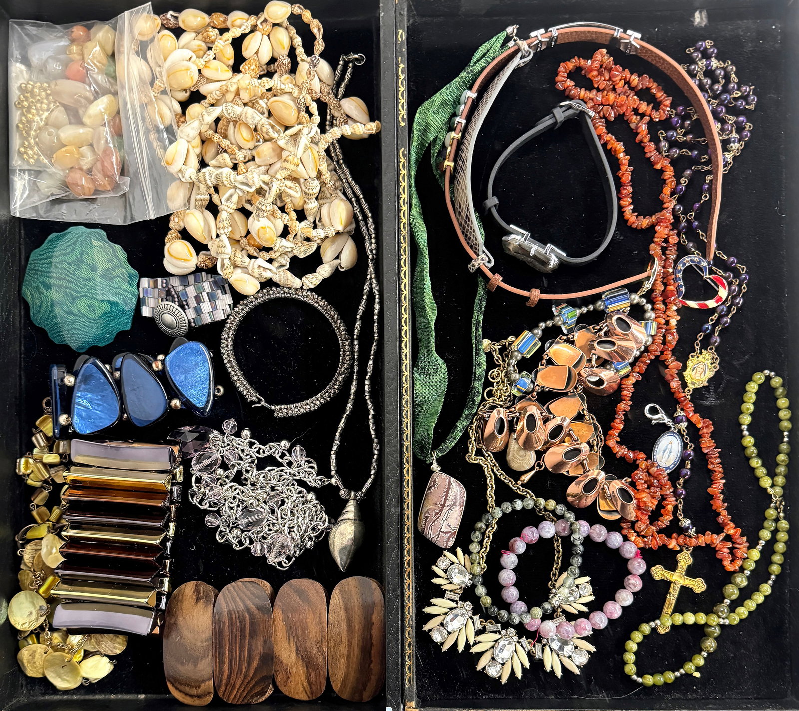 Assorted Costume Jewelry - Shells & More.: The lot contains necklaces, bracelets, and loose stones. Some of the materials used are seashells, jasper, rhinestones, mother of pearl, wood, enamel, and more. The brands included are Renoir and J. C