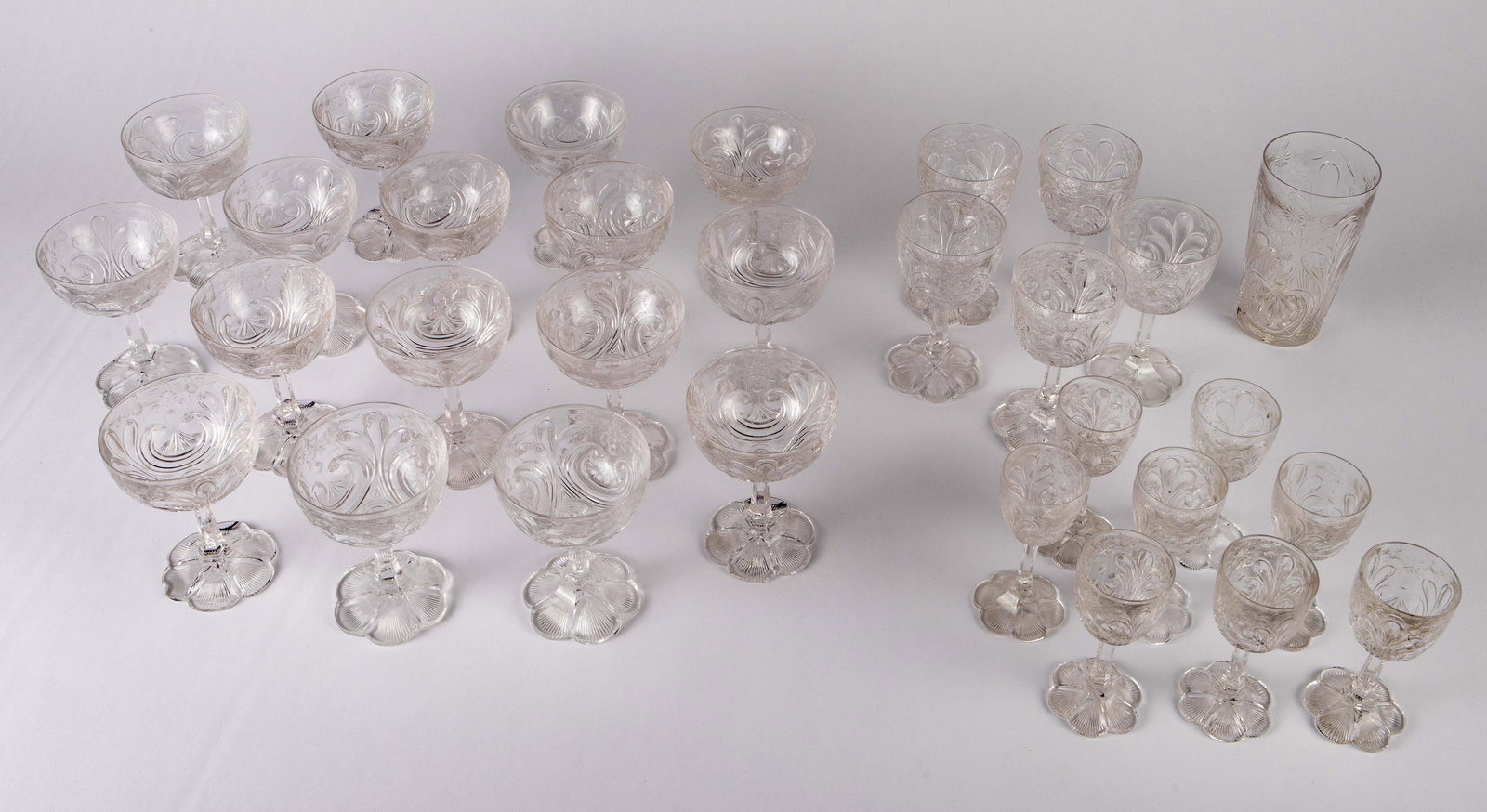 30 Pc. Set of Hawkes Glasses - Unusual Pattern.: The barware set includes sherbet glasses, port wine glasses, sherry glasses, and a highball glass, all with an elaborate flower motif. The bases also resemble flowers. Several of the glasses have chip