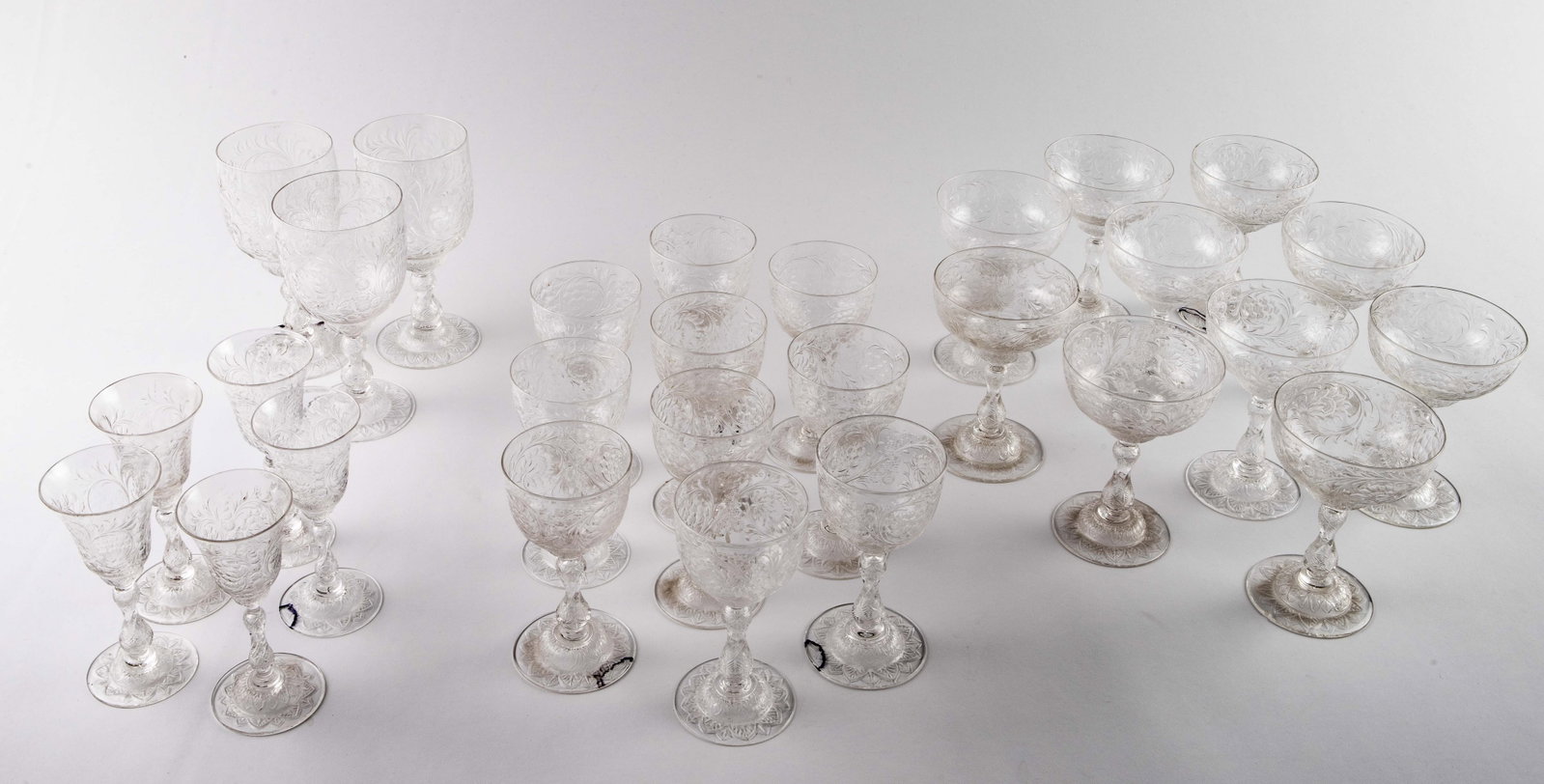 28 Pc. Set of Hawkes Stemware- Unusual Pattern.: Some of the pieces are signed, "Hawkes" underneath. This set has an elaborate flower and leaf pattern, with bases that resemble open sunflowers. It includes wine goblets, sherbet glasses or champagne 