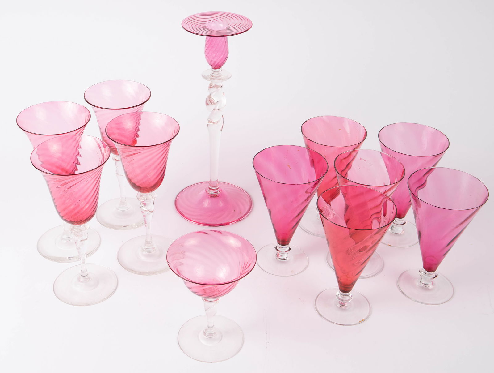 Lot of Steuben Pink Swirl Glassware.: This lot includes a 12" twisted and swirled candlestick, 4 wine or water goblets, a sherbet glass, and 5 parfait glasses. The candlestick is signed Steuben. Four of the parfait glasses have chips, but