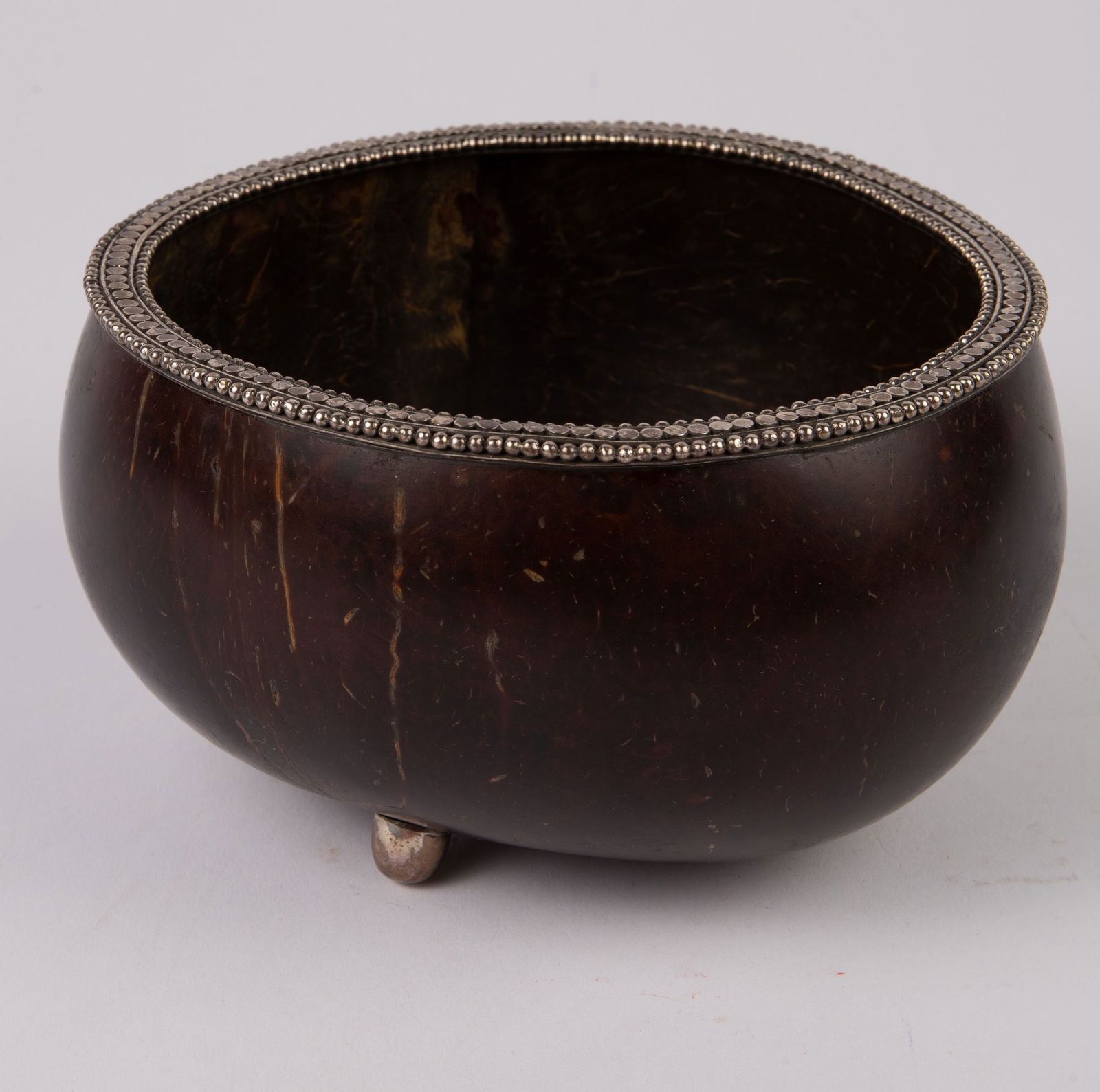 John Hardy "Coconut" Sterling Silver Bowl.: This designer coconut bowl features sterling silver details. It is appropriately branded on the underside. It measures 3 1/4" tall and roughly 6" in diameter. The piece is in overall good condition. I