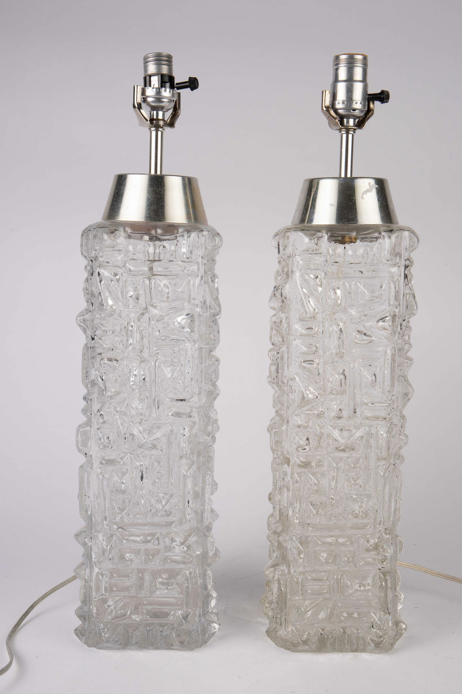 Pair of Carl Fagerlund? Pukeberg Glass Lamps.: They are Brutalist style glass lamps, both missing their harps. Aside from some scratches, they look to be in overall good cosmetic condition. Each lamp measures 21 5/8" tall. Third-party shipping or
